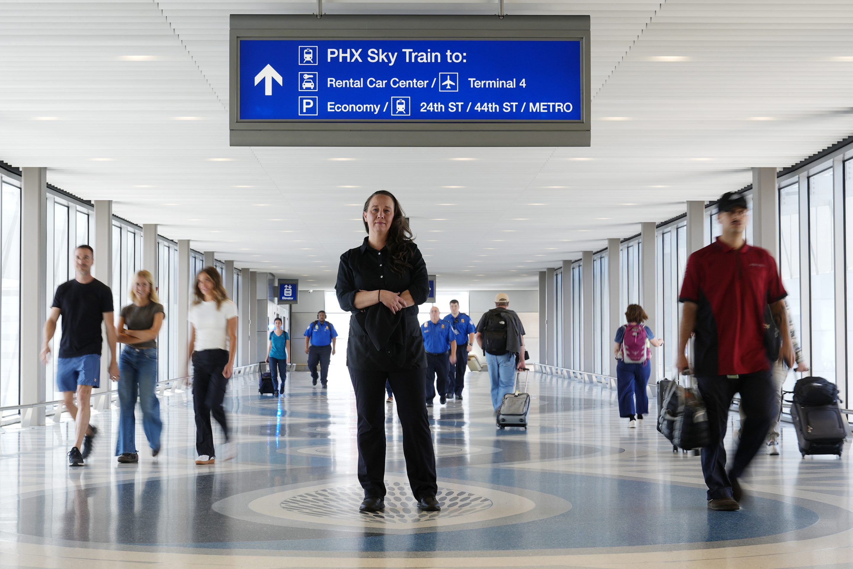 Lindsay Ruck, a server at Phoenix Sky Harbor International Airport restaurants, pauses in Terminal 3 as she is anticipates the vote on Arizona Prop 138 on minimum wage, on Oct. 3, 2024, in Phoenix.