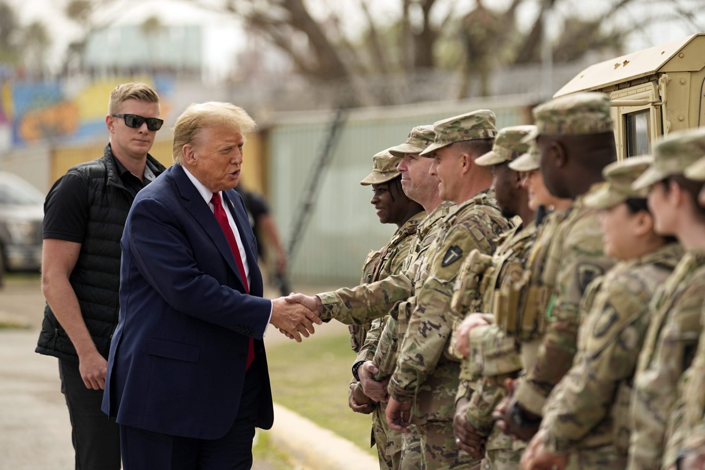 Trump shakes hands with soldiers