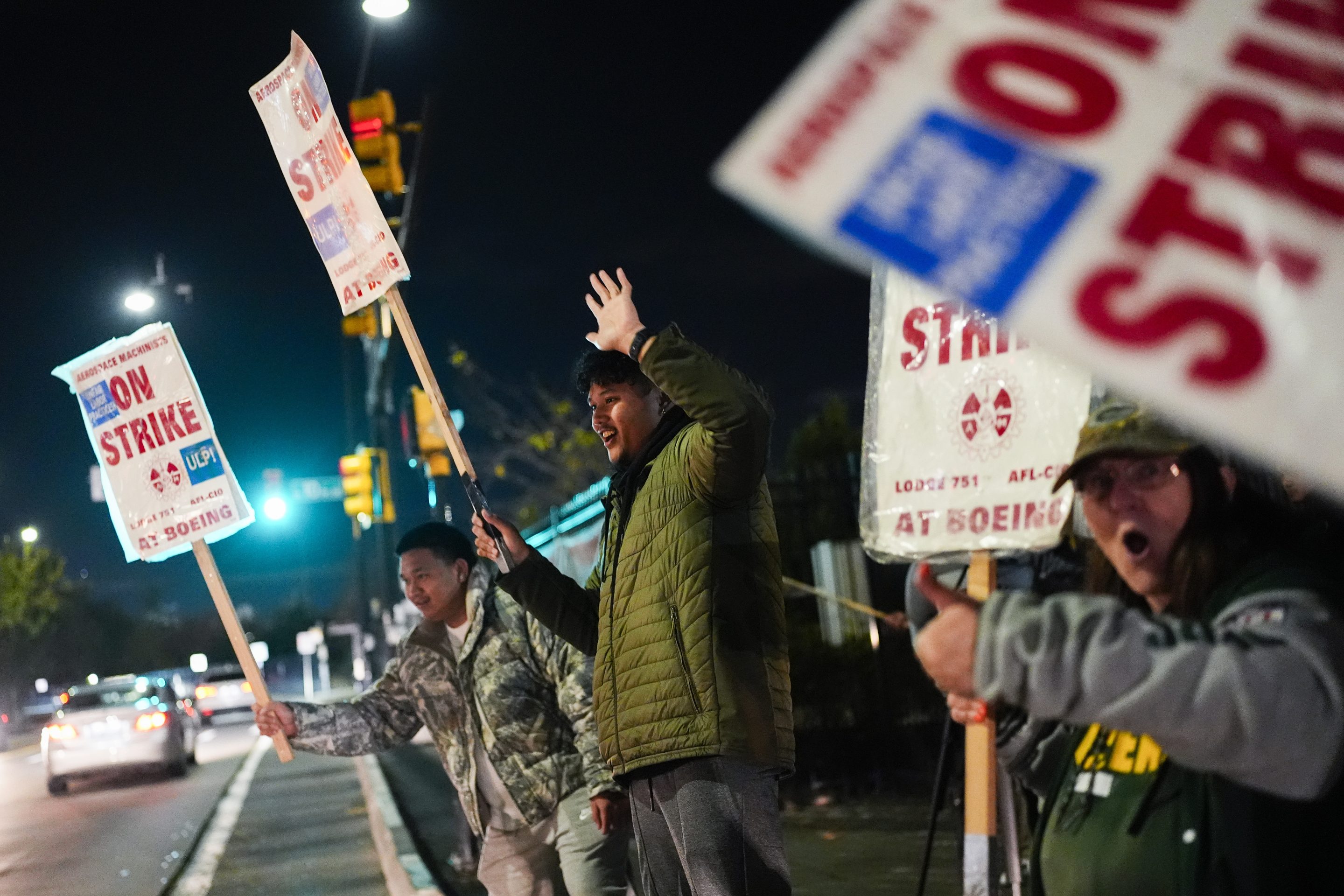 Boeing employees, including assembler Tyrone Hipolito, center, work the picket line after union members voted to reject a new contract offer from the company, on Oct. 23, 2024, in Renton, Wash.