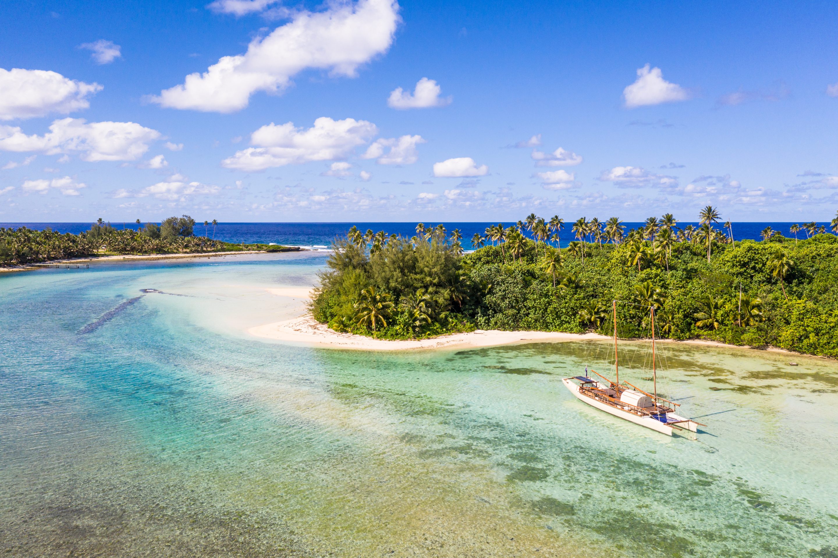 Photo of a sailboat in a peaceful blue lagoon