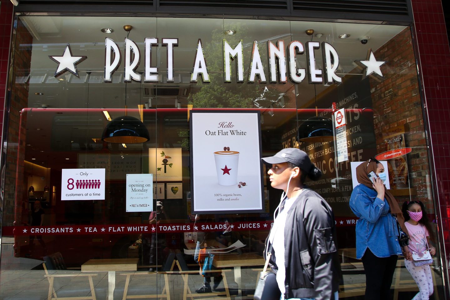 A person walking past Pret A Manger in London.