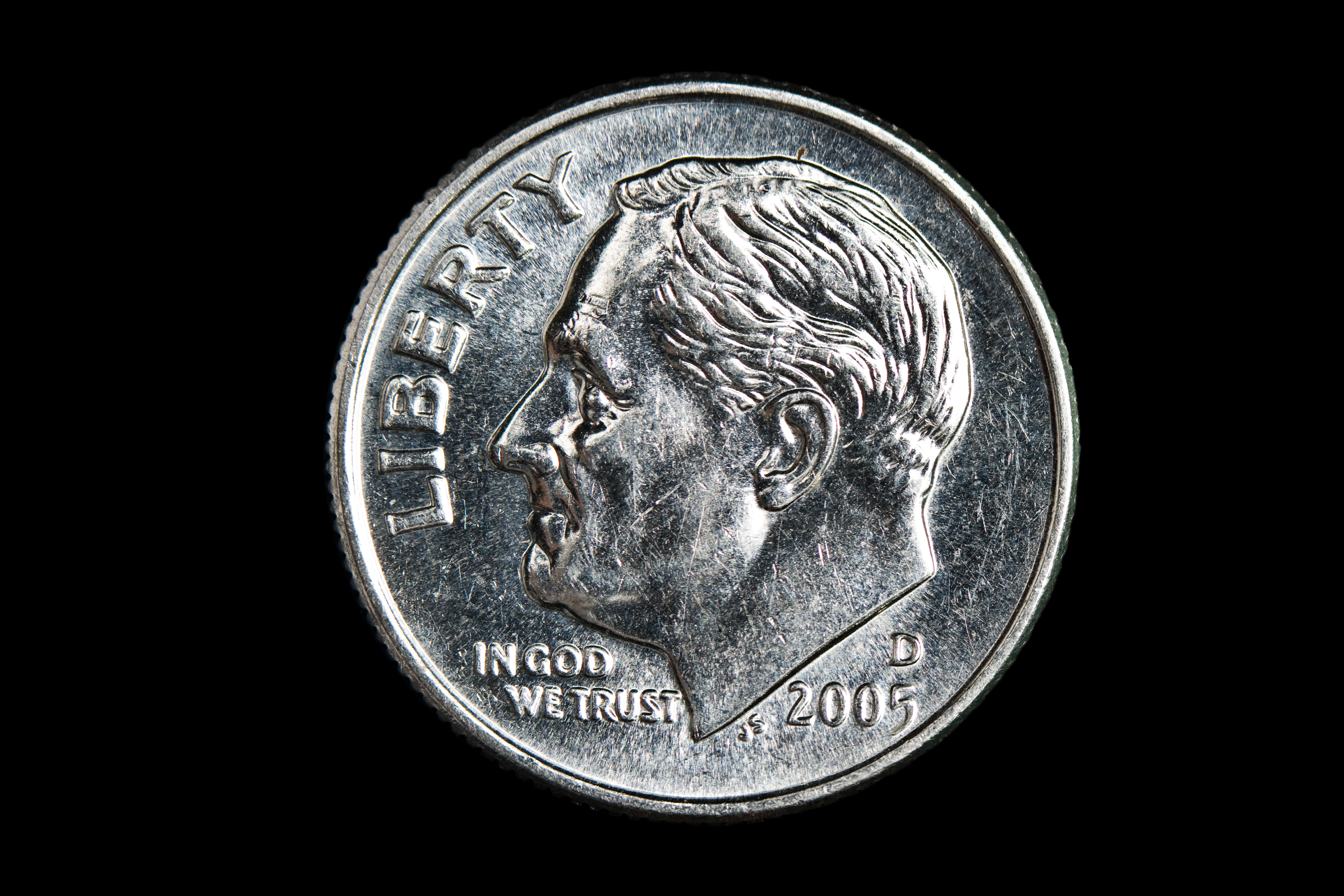 Dime on black background.