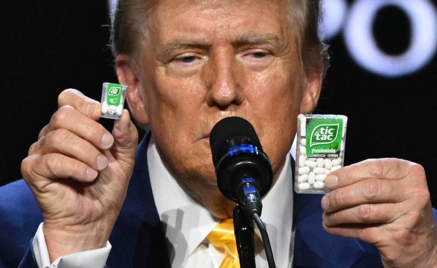 Former U.S. president and 2024 Republican presidential candidate Donald Trump holds a big and a small box of tic-tac to illustrate inflation outcomes during a town hall event in Phoenix, Arizona on Jun. 6.