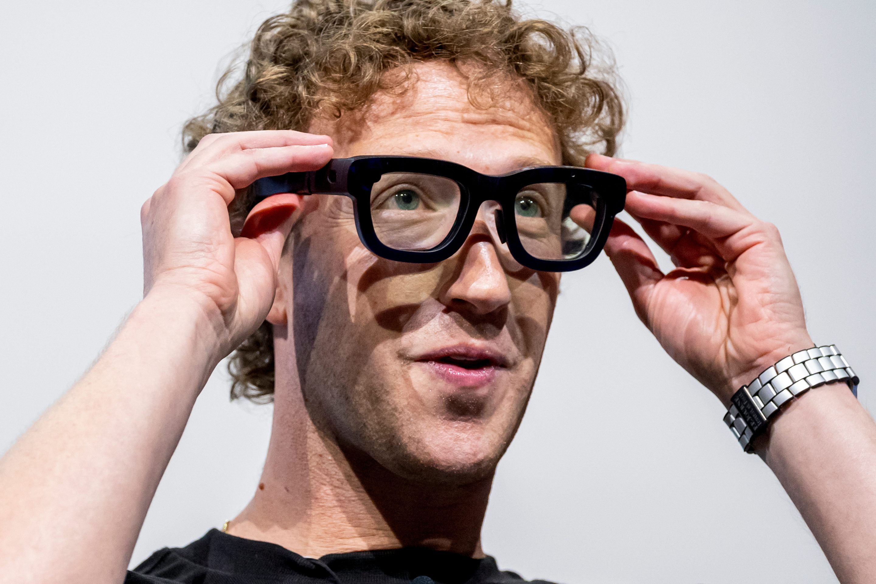 Meta CEO Mark Zuckerberg tries on a pair of AI-powered glasses