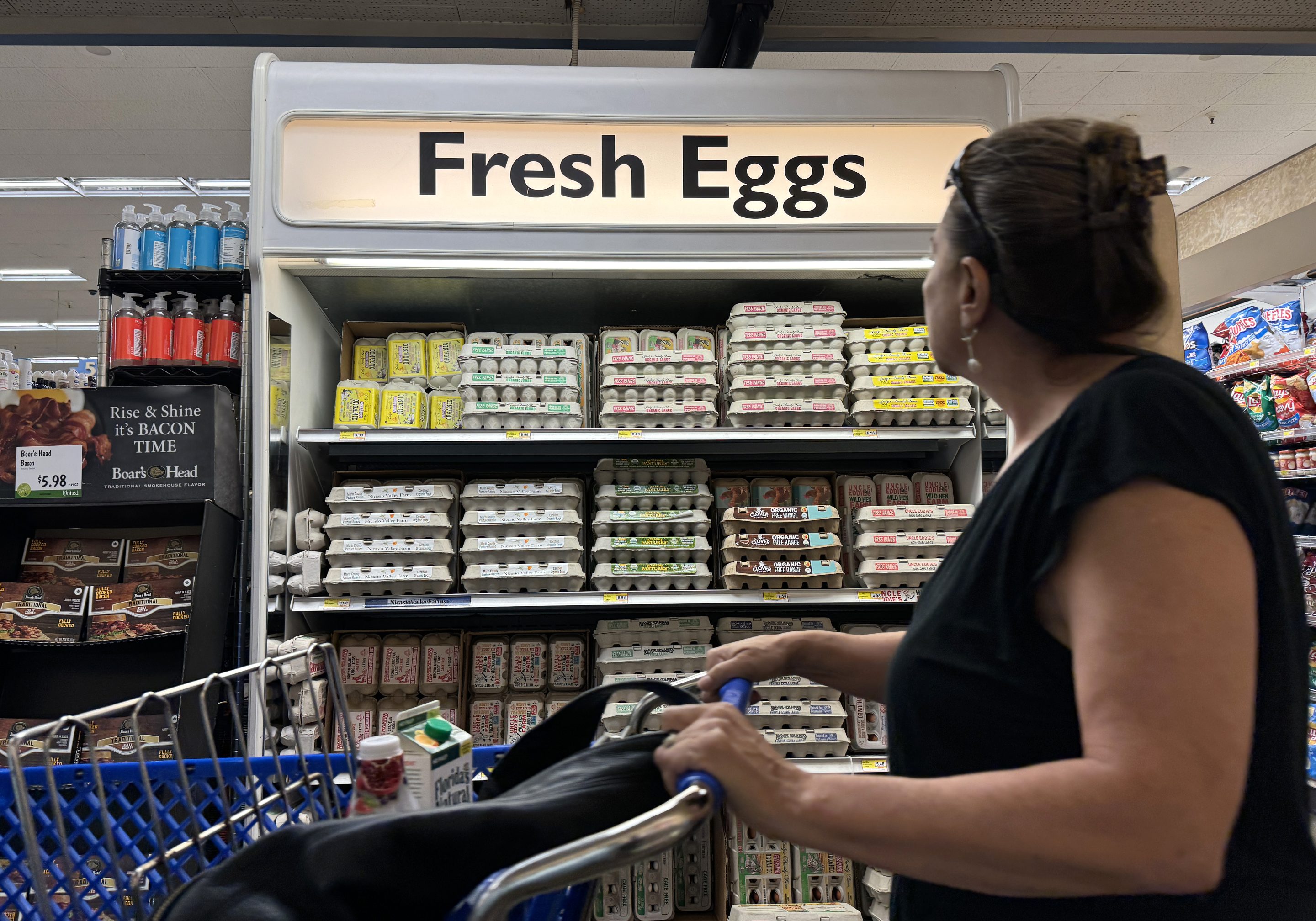 A customer walks by a display of fresh eggs at a grocery store on Sep. 25, 2024 in San Anselmo, California.