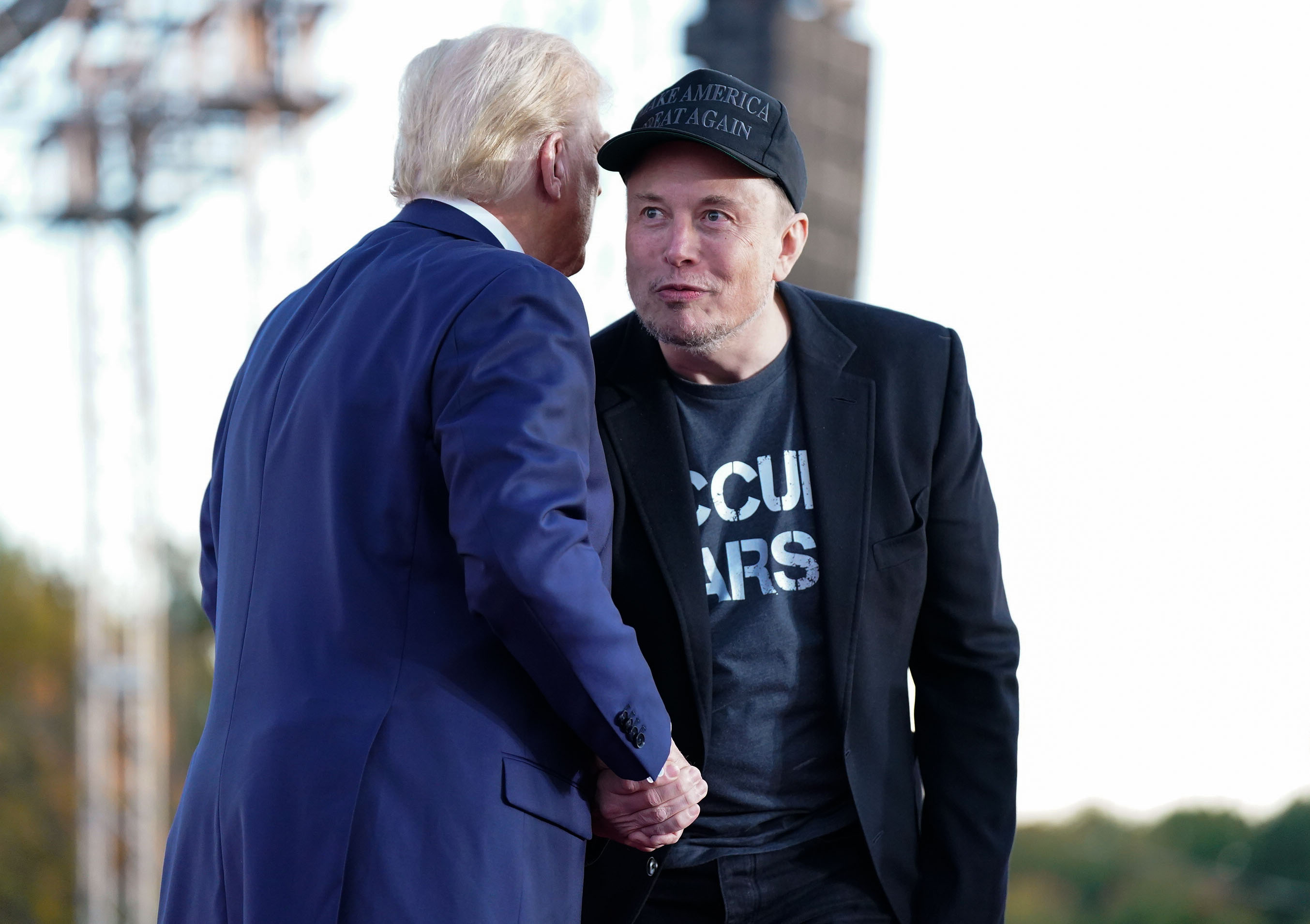 Tesla and SpaceX CEO Elon Musk speaks with former president Donald Trump