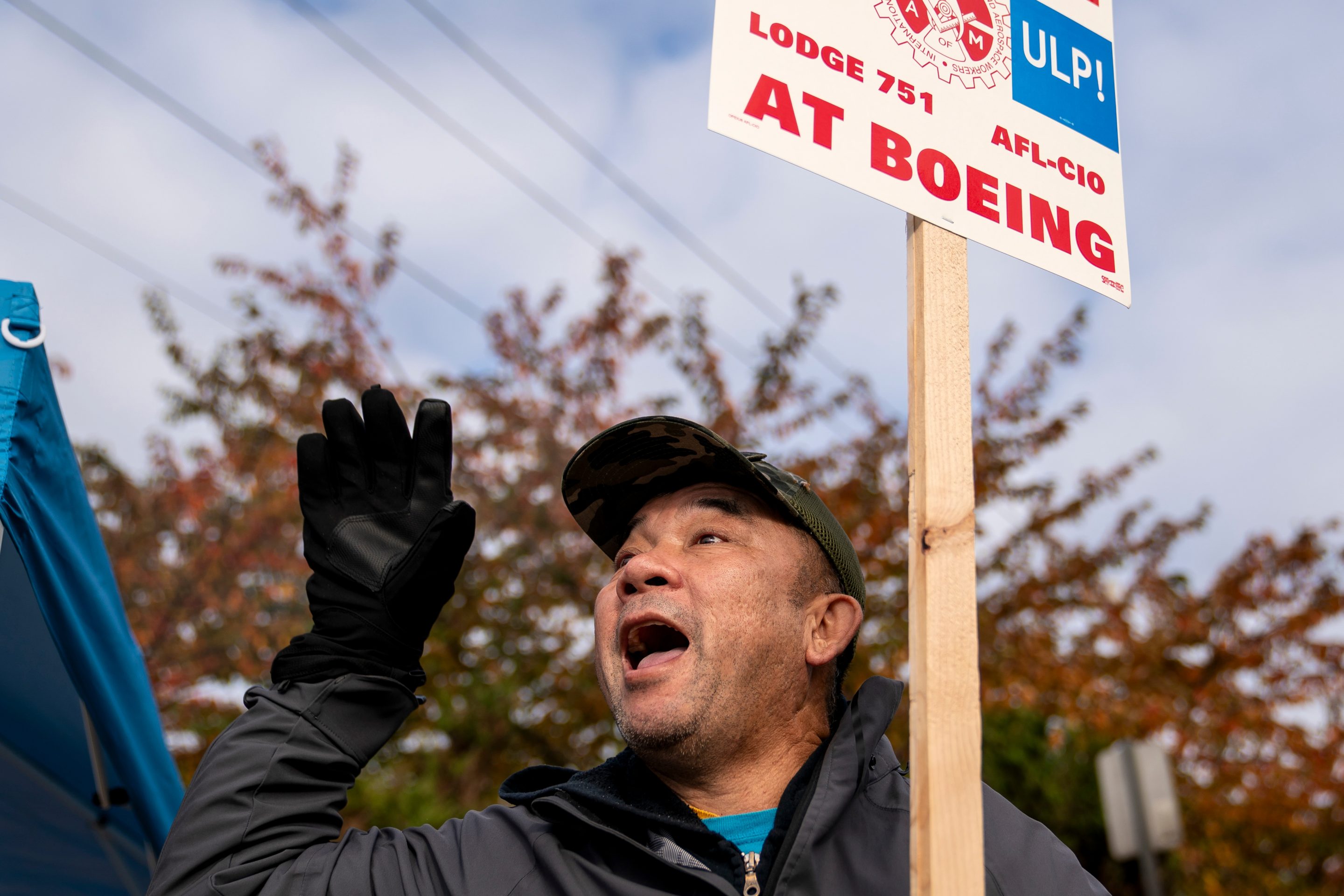 A striking worker holds a picket sign.