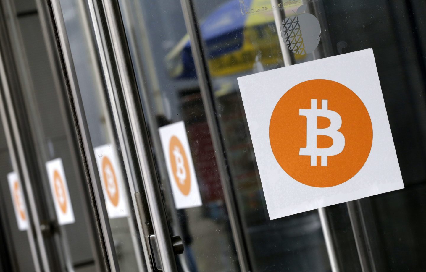 Bitcoin logos are displayed at the Inside Bitcoins conference and trade show on April 7, 2014, in New York.
