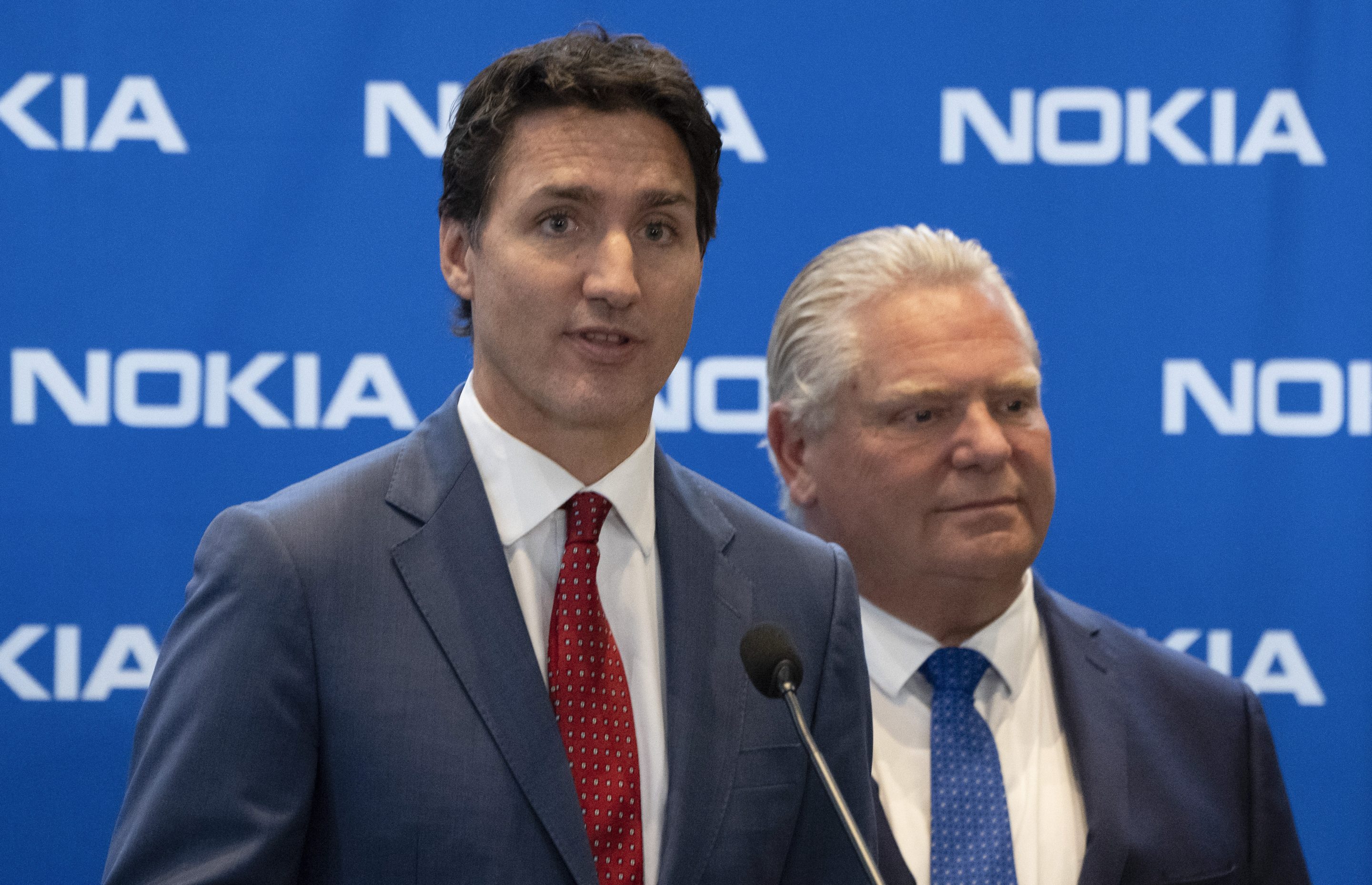 Prime Minister Justin Trudeau, left, responds to a question as Ontario Premier Doug Ford looks on following an announcement of plans to turn Nokia's Ottawa facility into a research and development technology center in Ottawa, Ontario, on Oct. 17, 2022. 