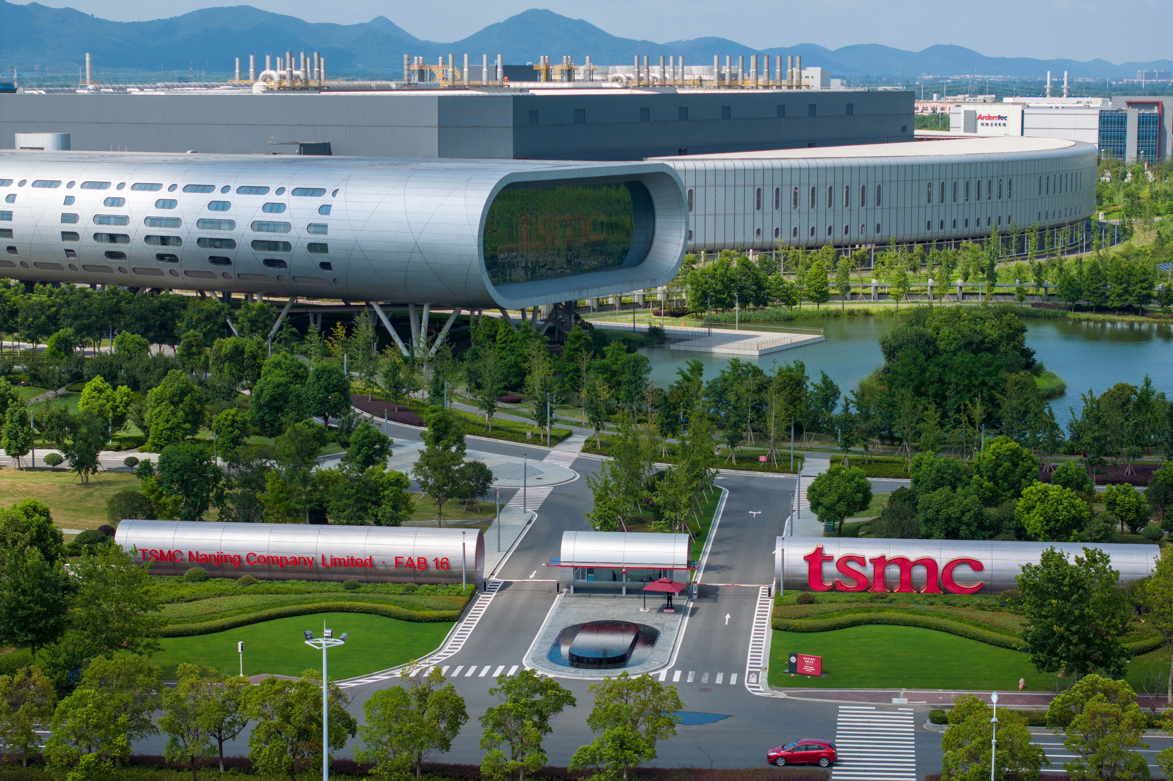 a factory building surrounded by greenery