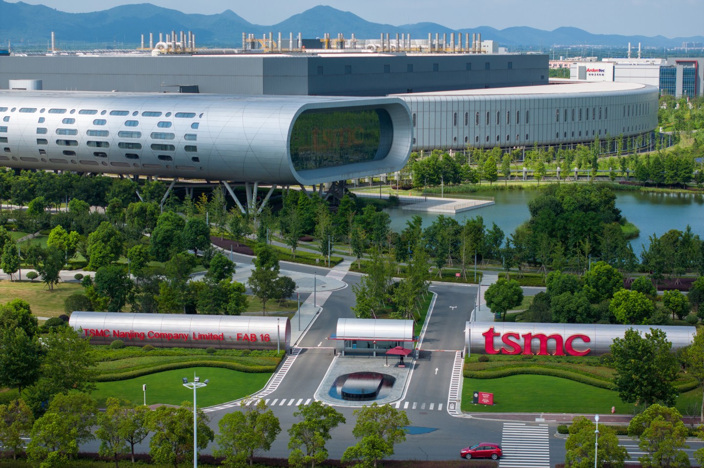 a factory building surrounded by greenery