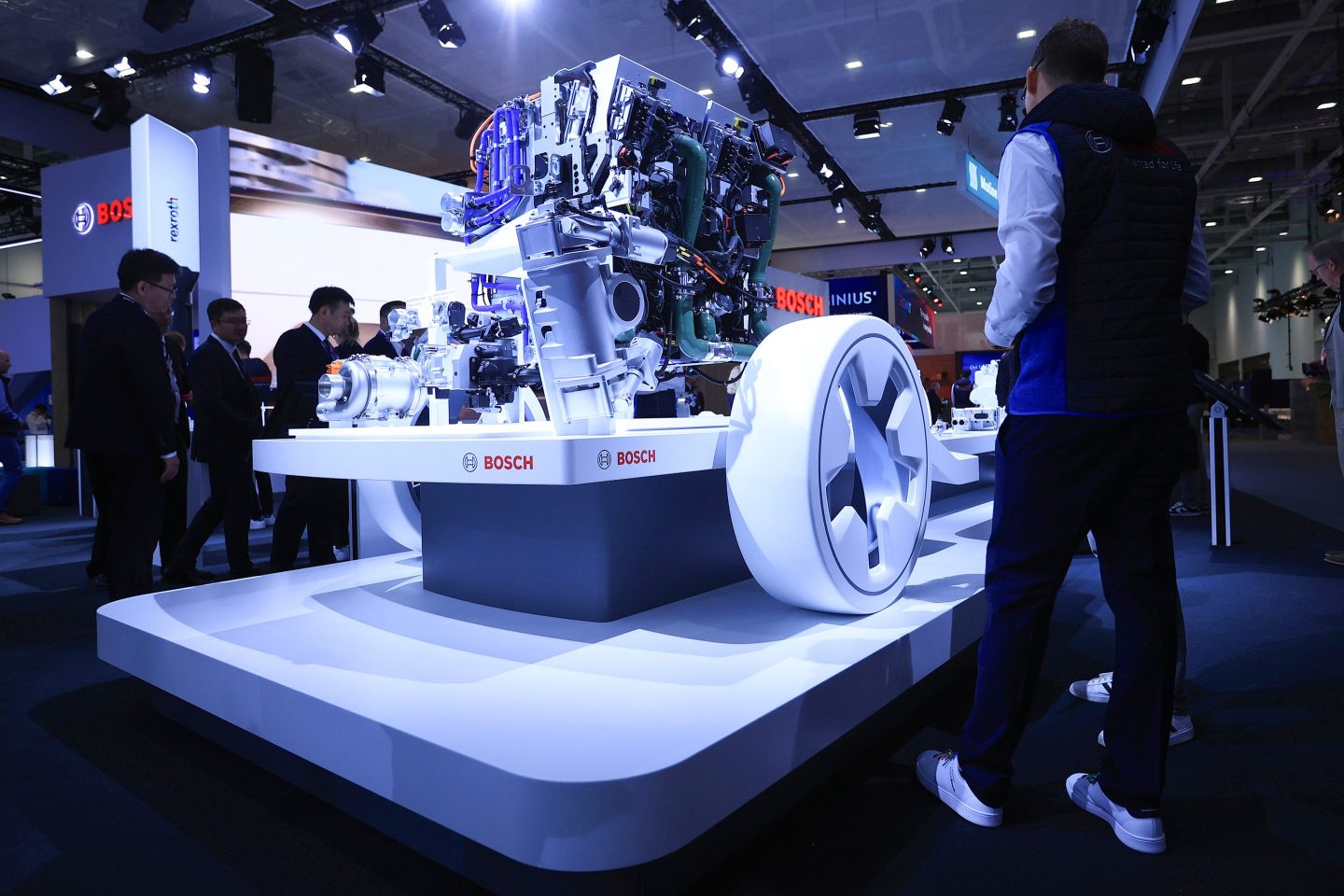 A worker dusts a fuel cell power module at the Robert Bosch GmbH booth at a transportation fair in Germany.