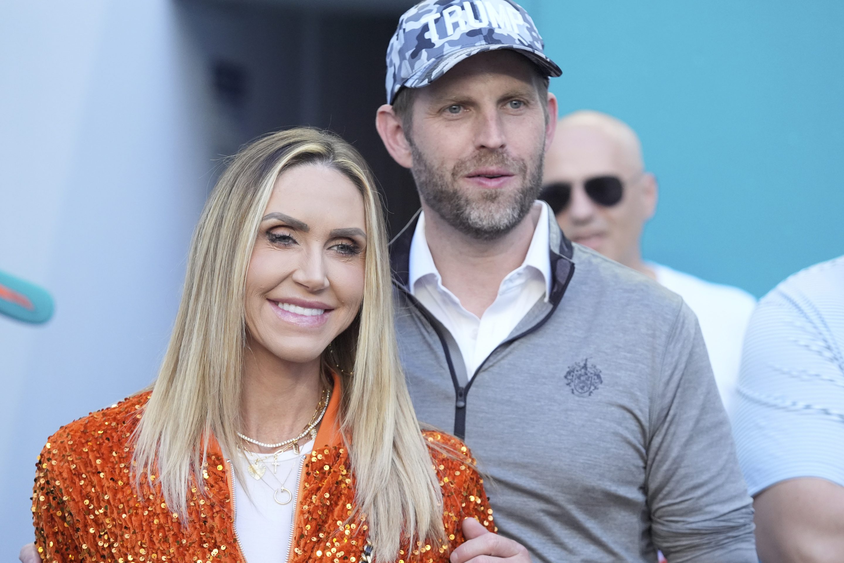 Eric and Lara Trump watch the second half of an NFL football game between the Miami Dolphins and the New England Patriots, Sunday, Nov. 24, 2024, in Miami Gardens, Fla.