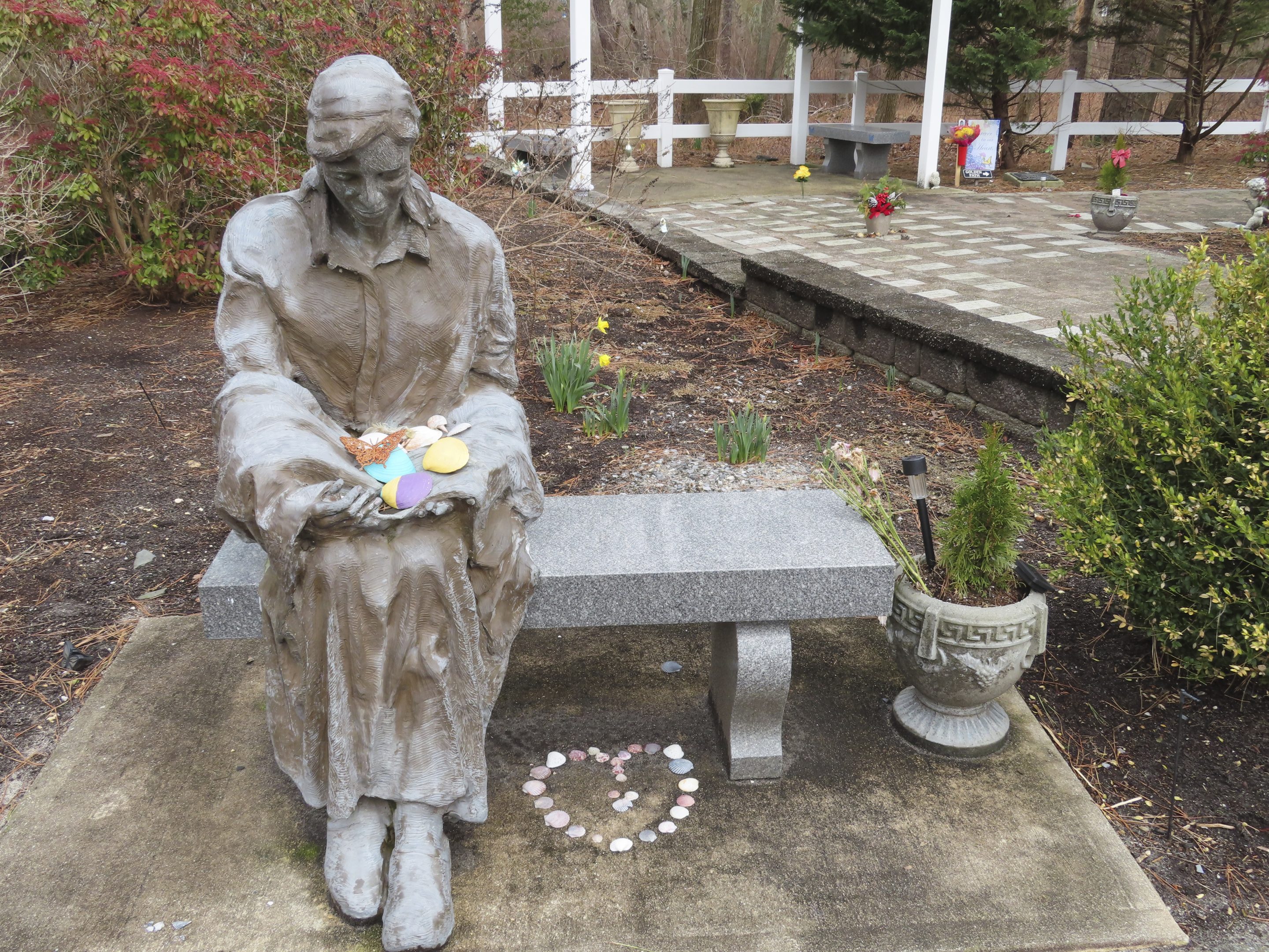 A sculpture of a grieving mother at a memorial garden in Toms River, N.J., for children who died from any cause is shown on Feb. 21, 2023.