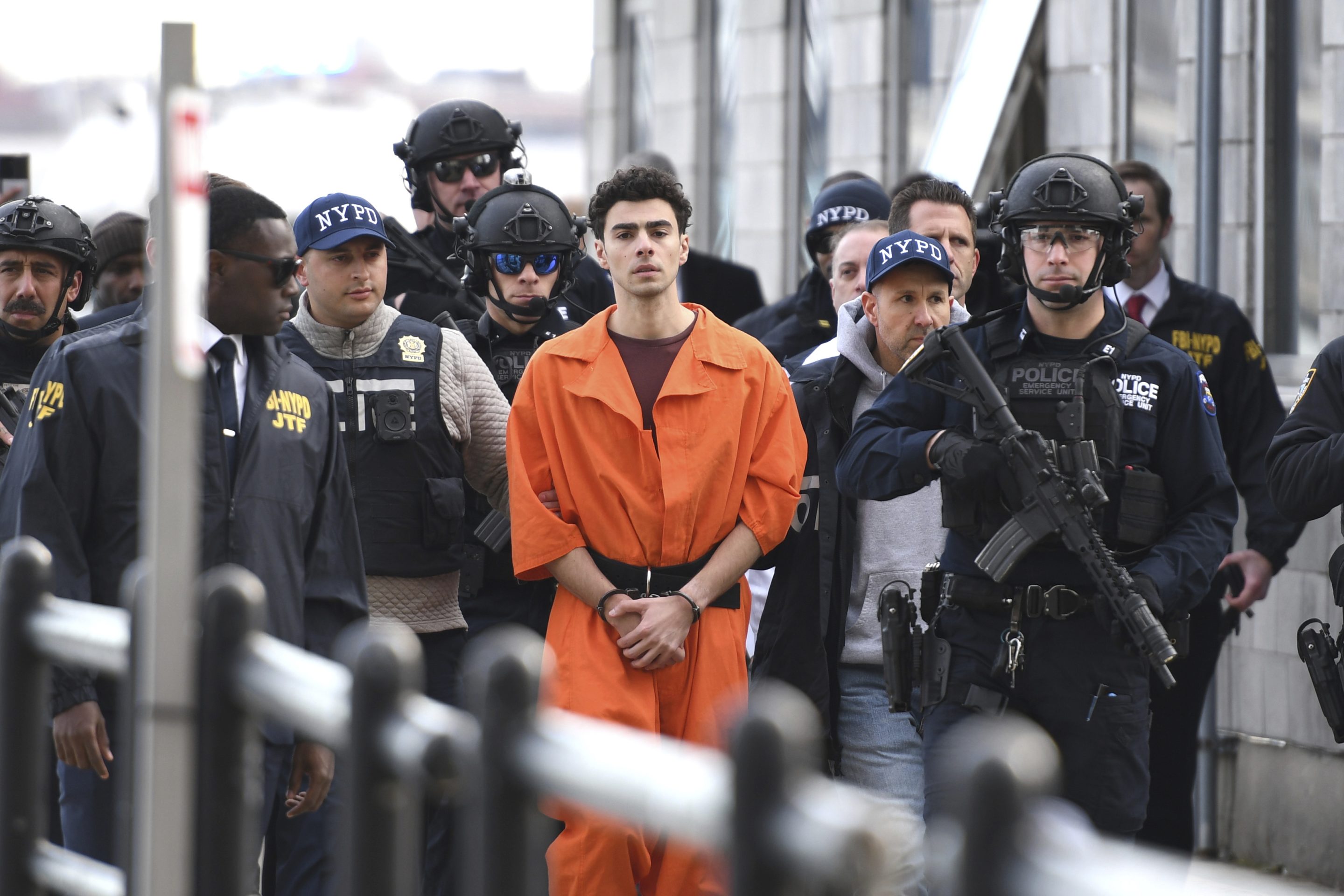 Luigi Mangione, a suspect in the fatal shooting of UnitedHealthcare CEO Brian Thompson, is escorted by police, on Dec. 19, 2024, in New York.