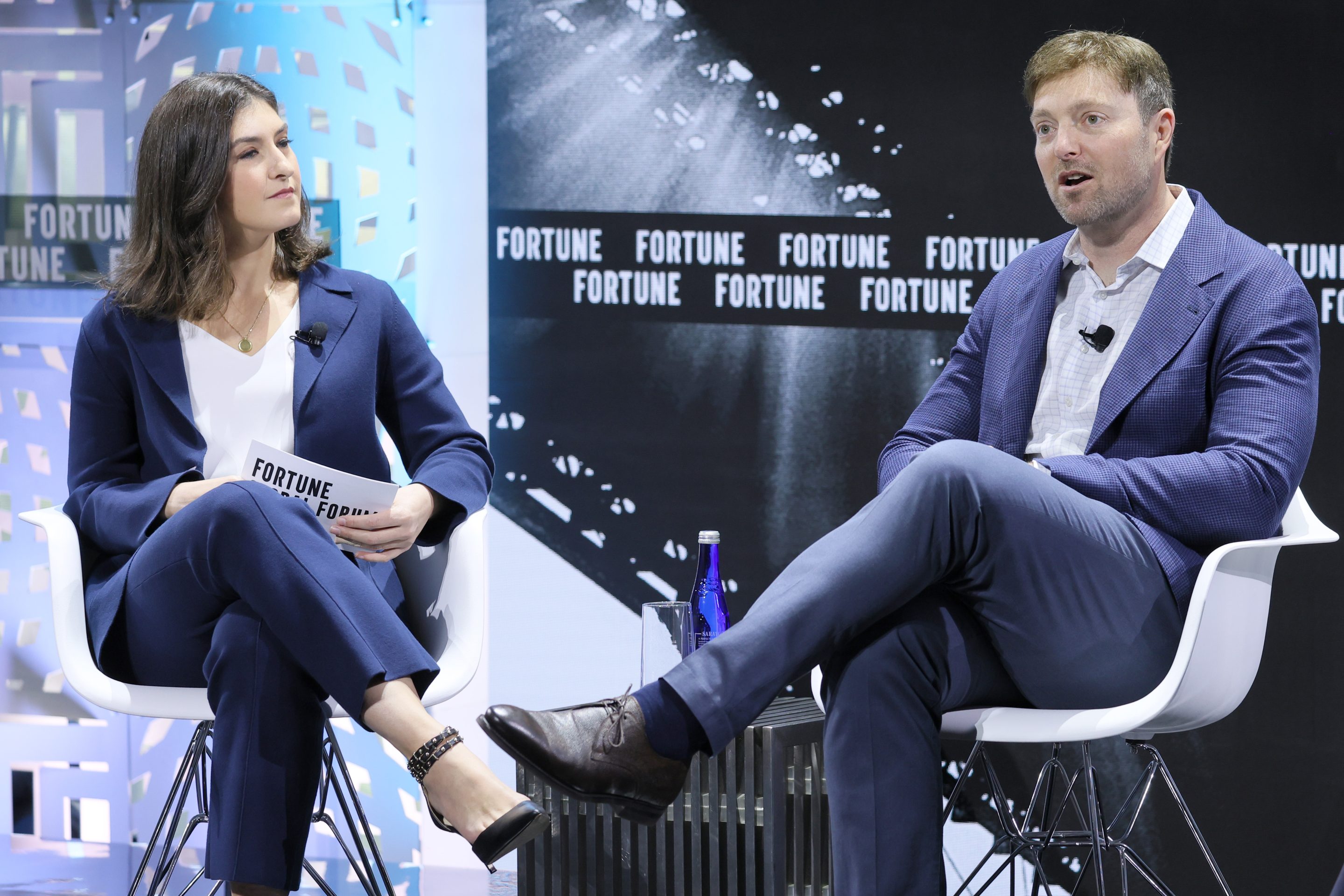 Alex Chriss sits and talks on stage with Fortune reporter Kristin Stoller.