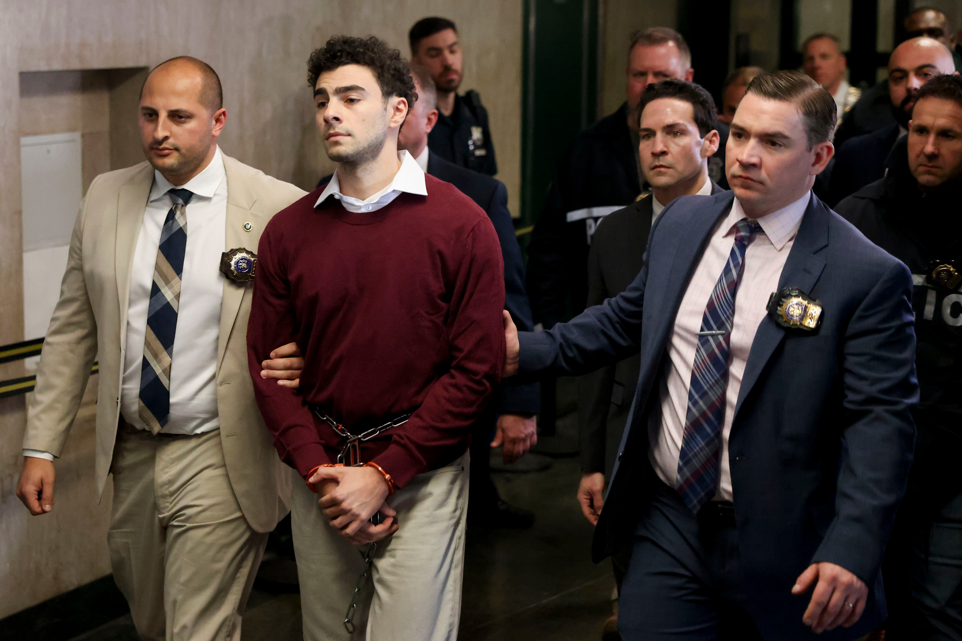 Luigi Mangione, the suspect in the killing of UnitedHealth Group Inc. chief executive officer Brian Thompson, center, exits New York State Supreme Court in New York, US, on Monday, Dec. 23, 2024.