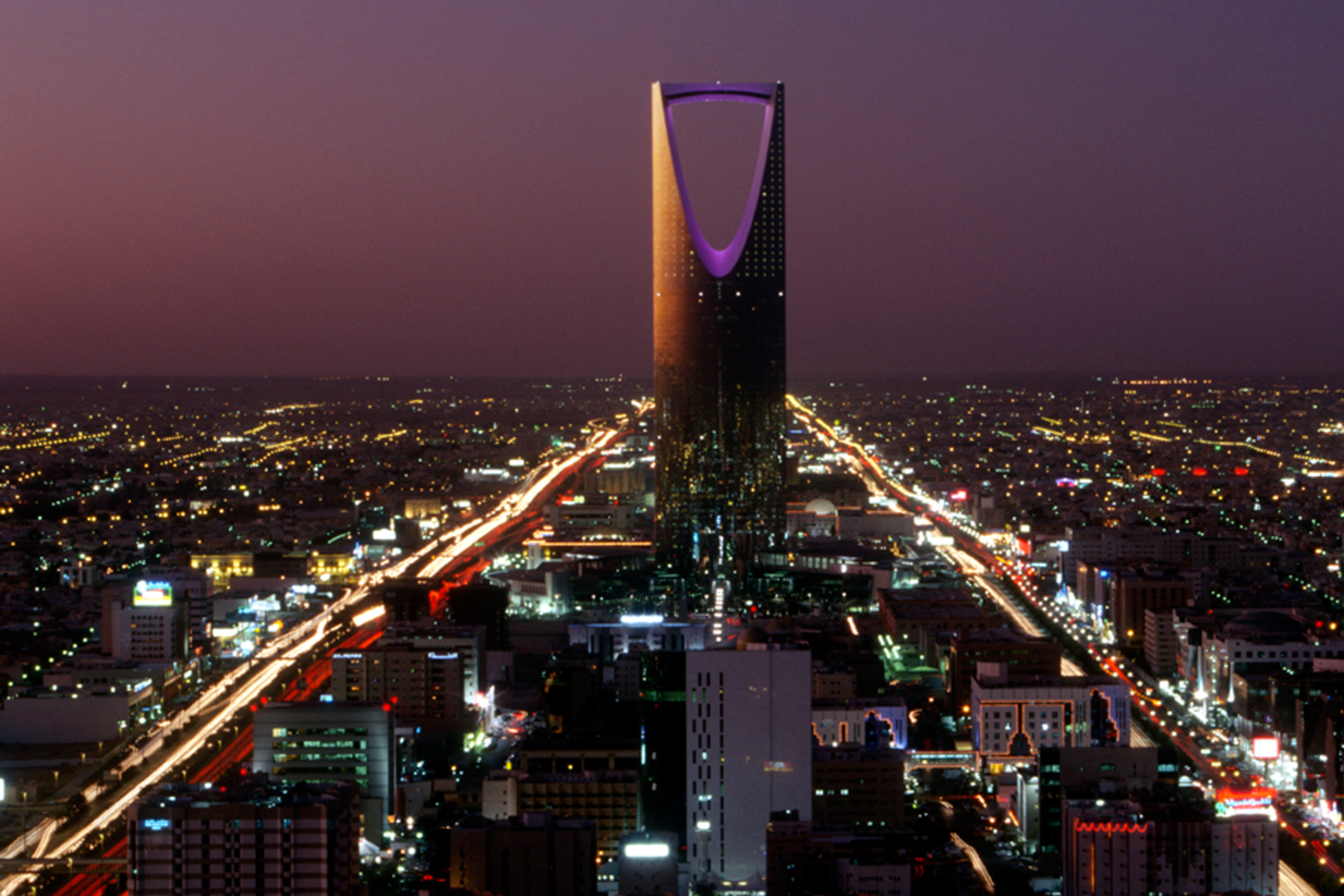 Kingdom Centre (Burj al-Mamlaka) dominates the evening cityscape in Riyadh, Saudi Arabia.