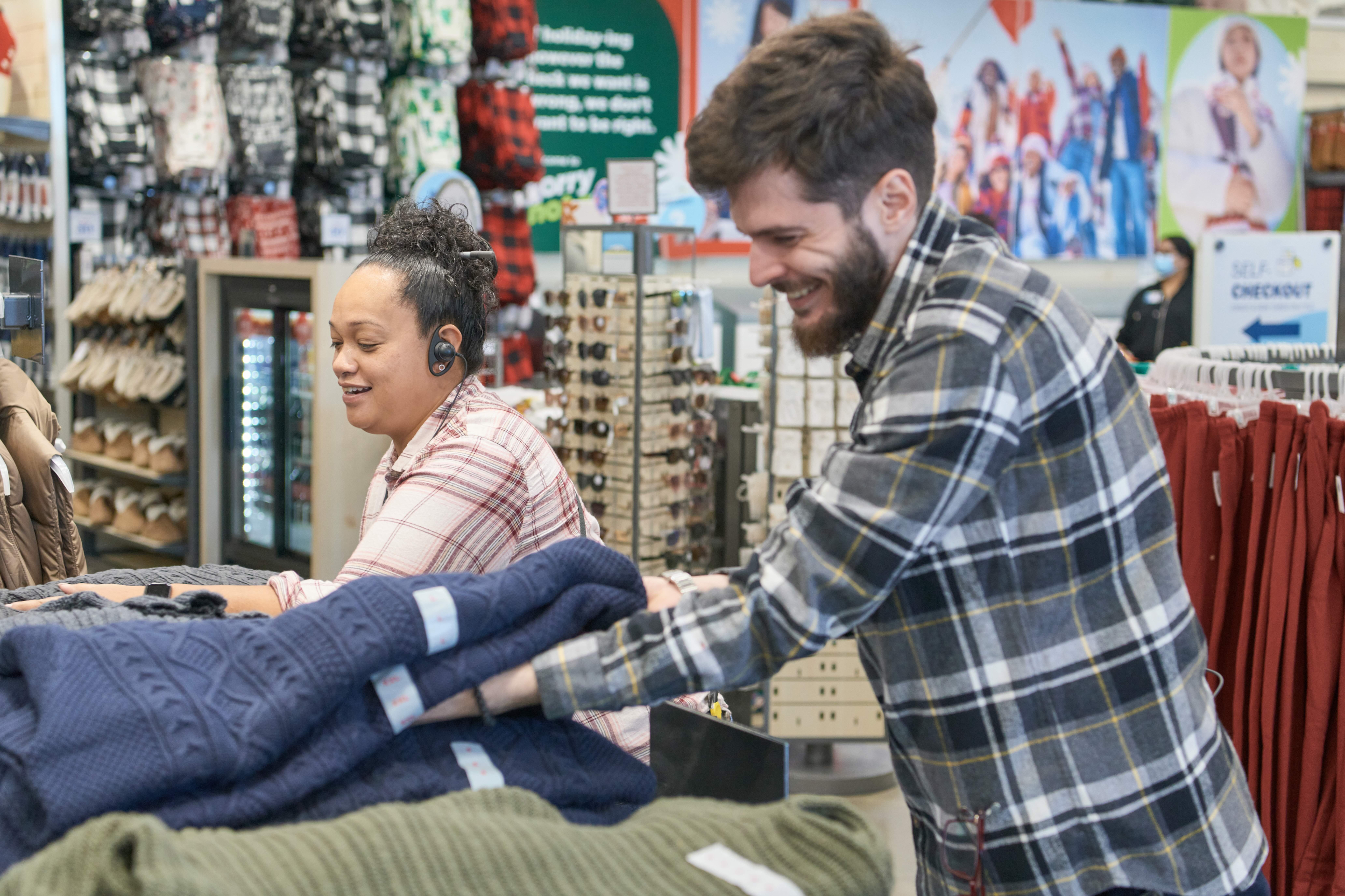 Two associates folding clothing.
