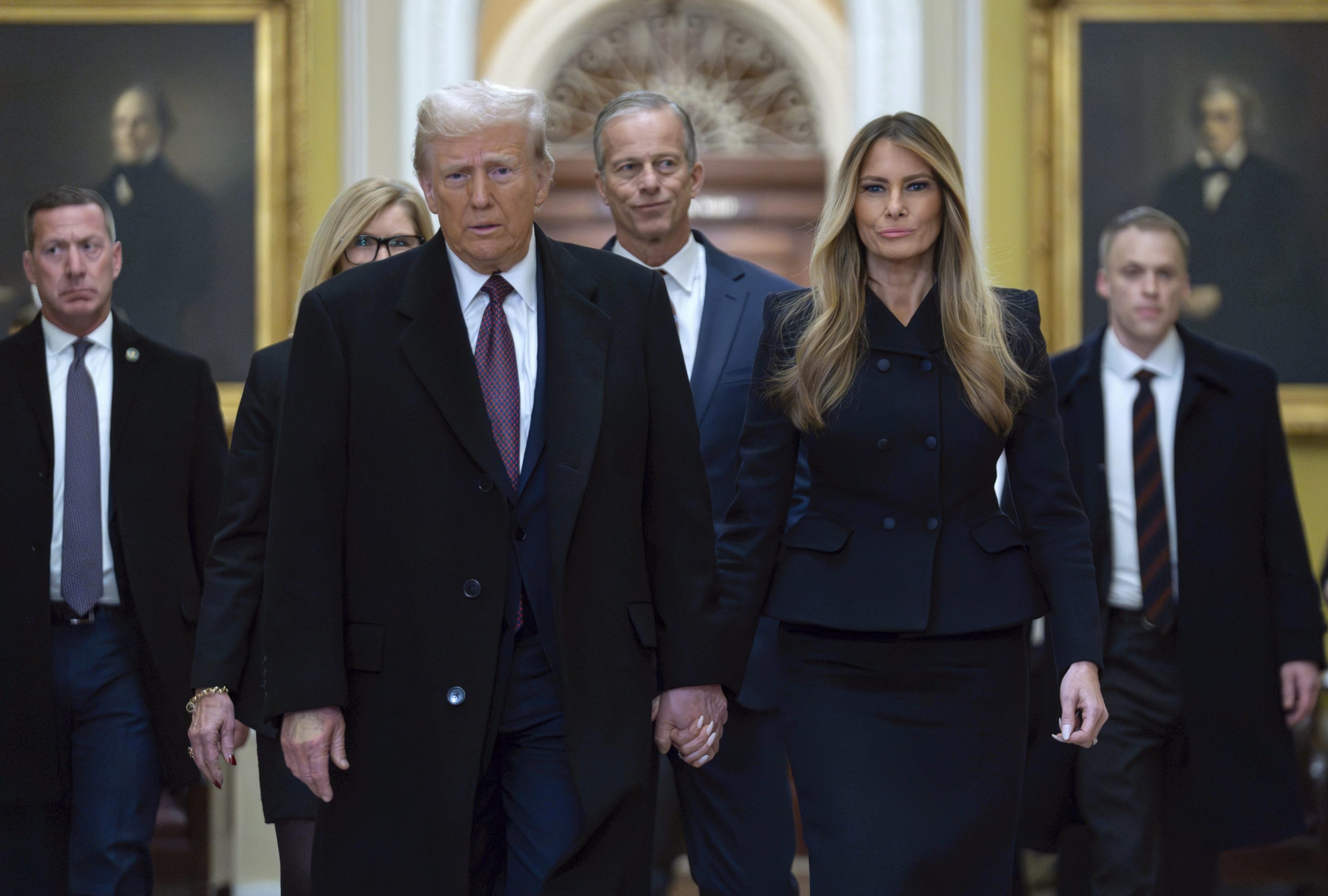 President-elect Donald Trump walks with Melania Trump at the Capitol, on Jan. 8, 2025, in Washington, followed by Senate Majority Leader John Thune, R-S.D.