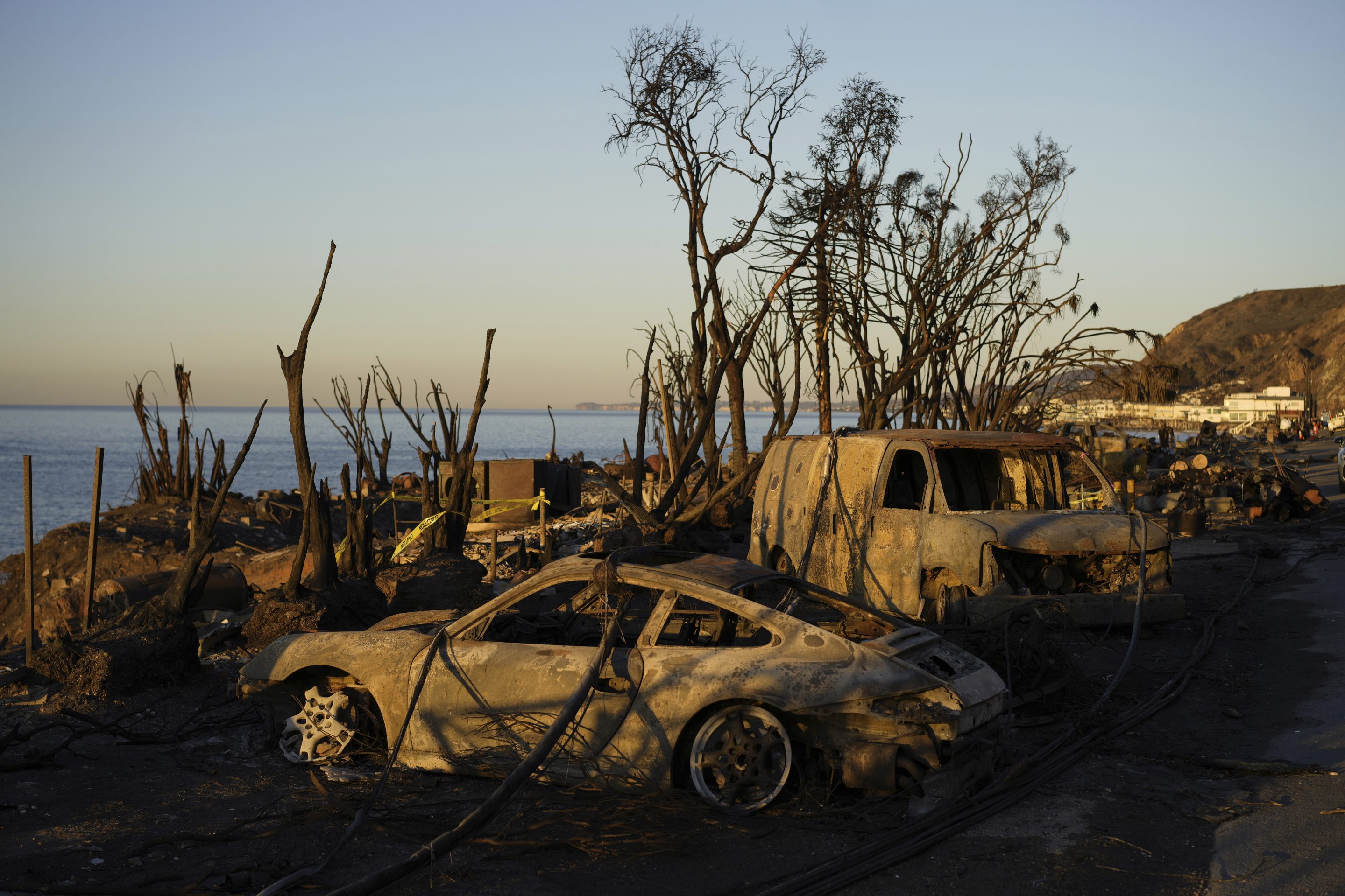 Charred vehicles sit along the Pacific Coast Highway, on Jan. 14, 2025, in Malibu, Calif.