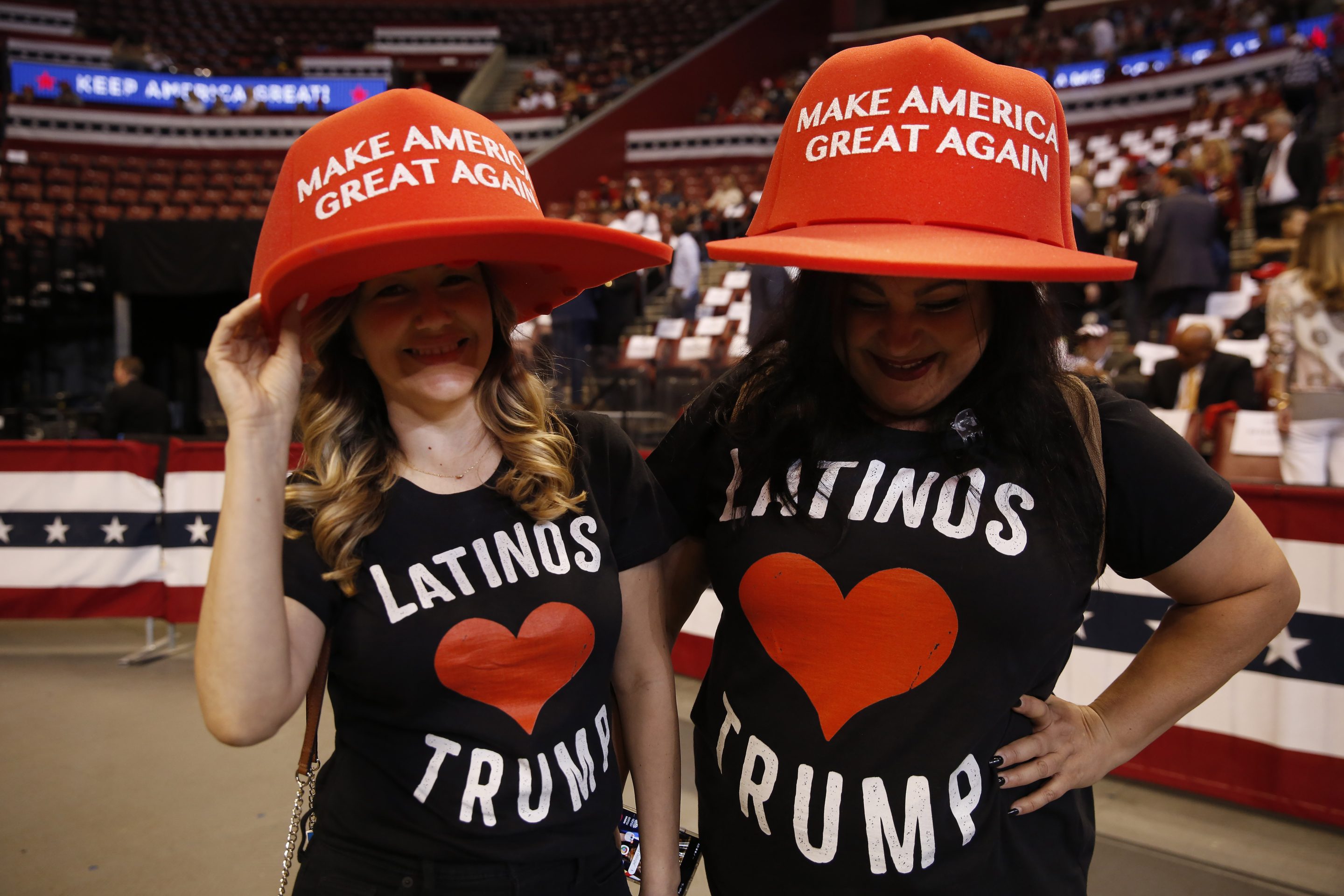 Supports wear large "Make America Great Again" hats before President Donald Trump's rally on Nov. 26, 2019, in Sunrise, Fla. 