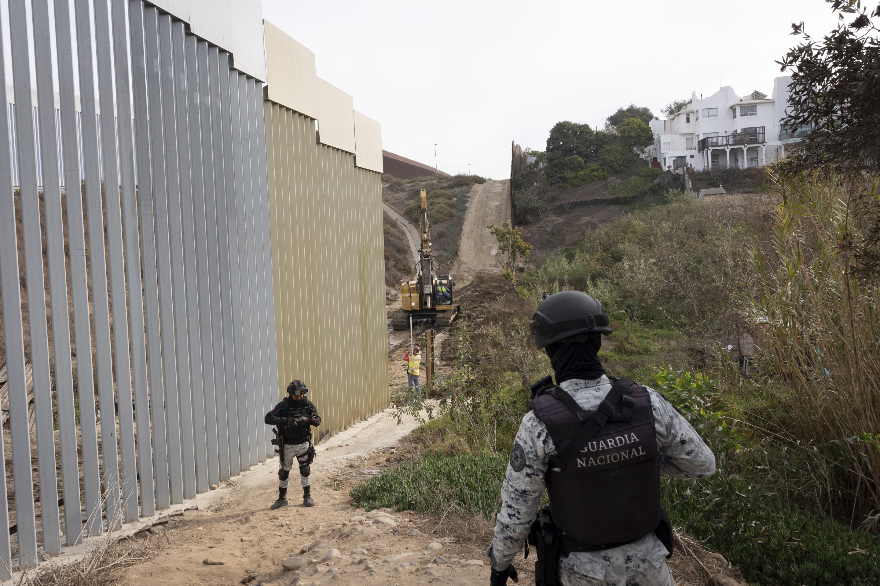 Members of the Mexican National Guard patrol as construction crews replace sections of one of two border walls separating Mexico from the United States, on Jan. 22, 2025, in Tijuana, Mexico. 