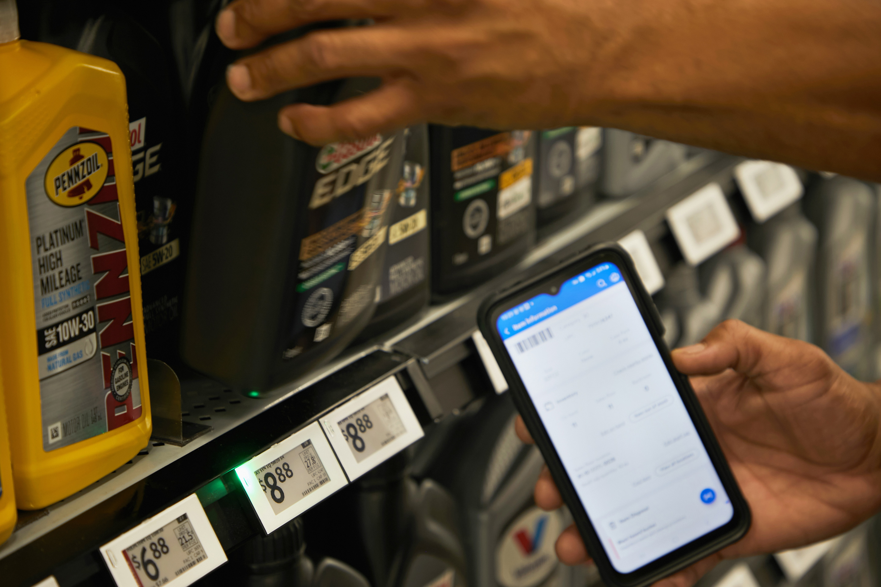An employee at a Walmart store in Grapevine, Texas. The world's biggest retailer is testing digital labels that light up when activated with an app. 