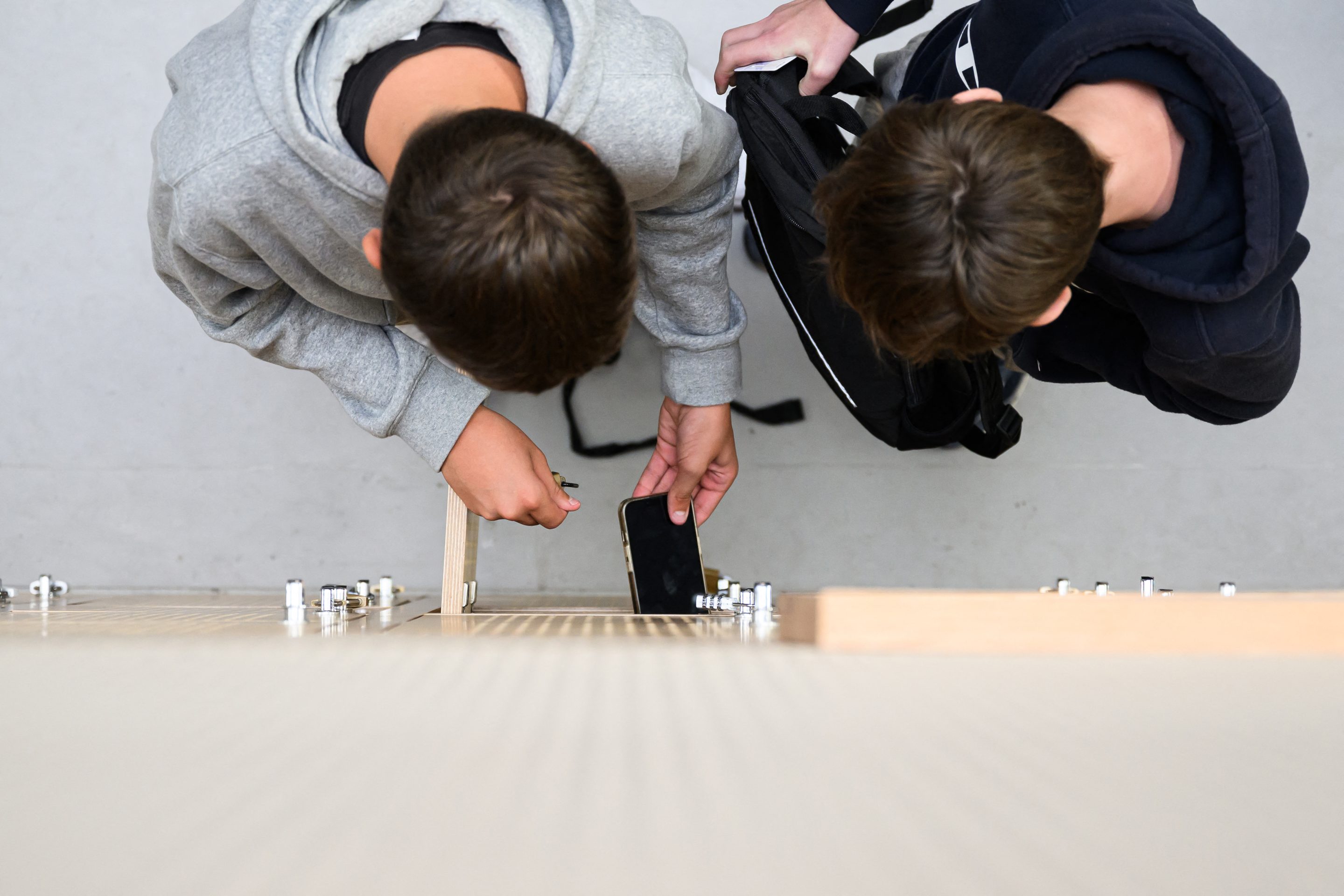 Students put their mobile phones in their lockers after switching them off