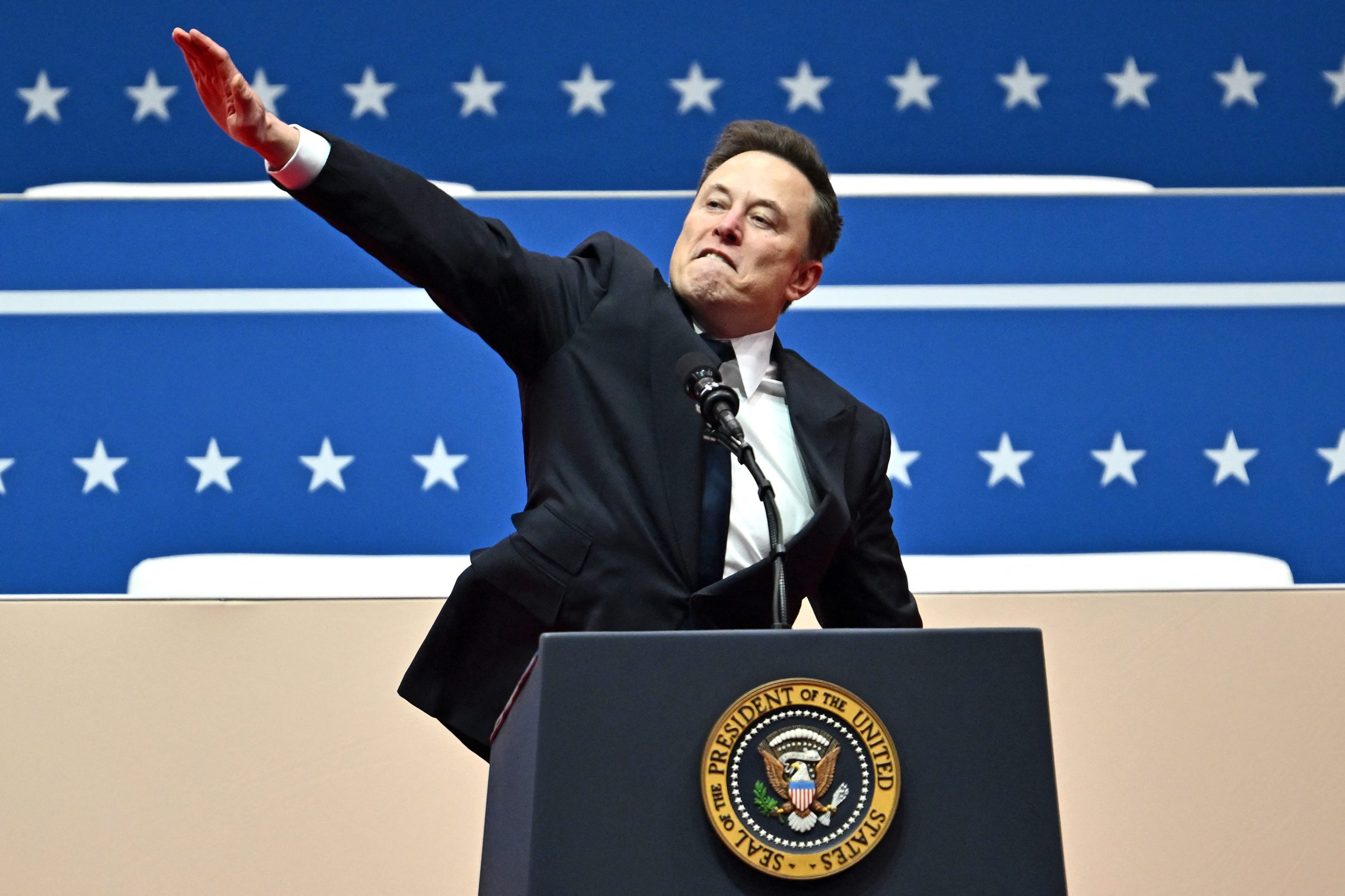 Tesla and SpaceX CEO Elon Musk gestures as he speaks during the inaugural parade inside Capitol One Arena, in Washington, DC, on January 20, 2025
