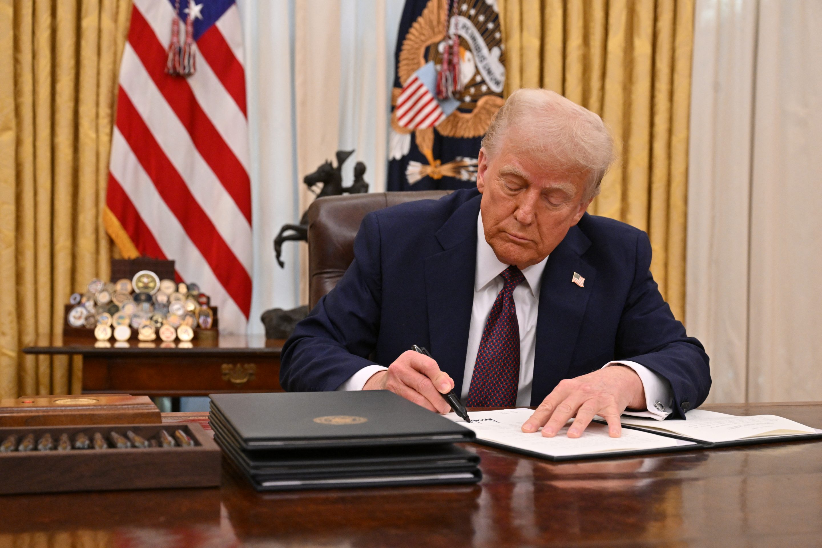 President Donald Trump signing an executive order.