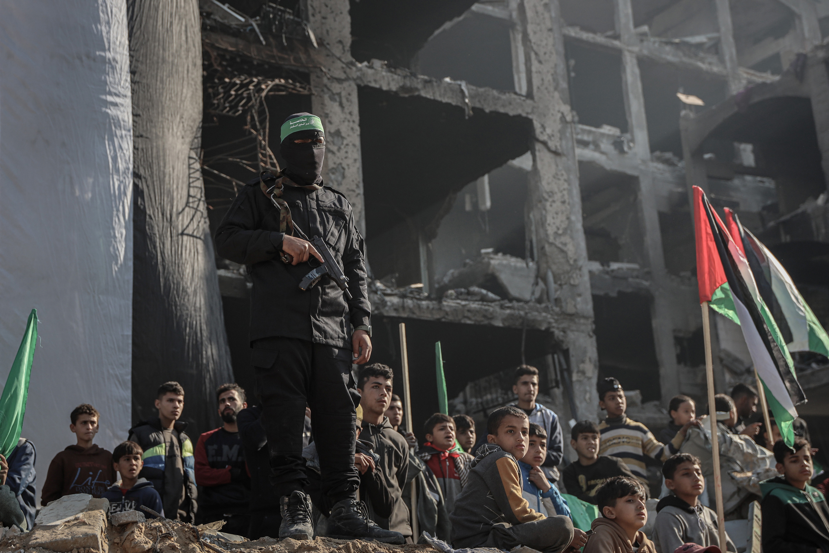 An armed Hamas militant keeps watch. International conflict is the primary concern among business leaders in 2025.
