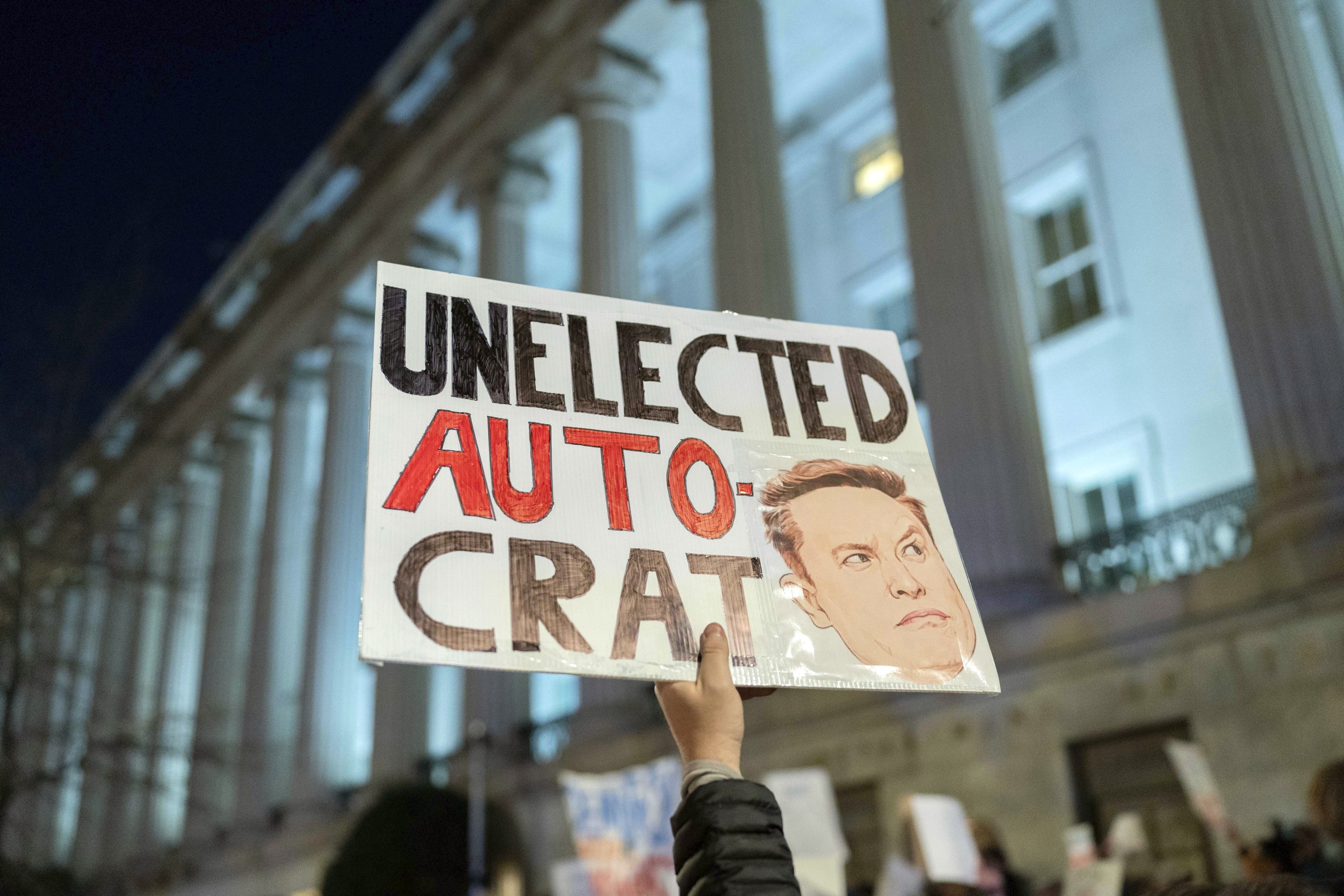 People protest during a rally against Elon Musk outside the Treasury Department in Washington, on Feb. 4, 2025.