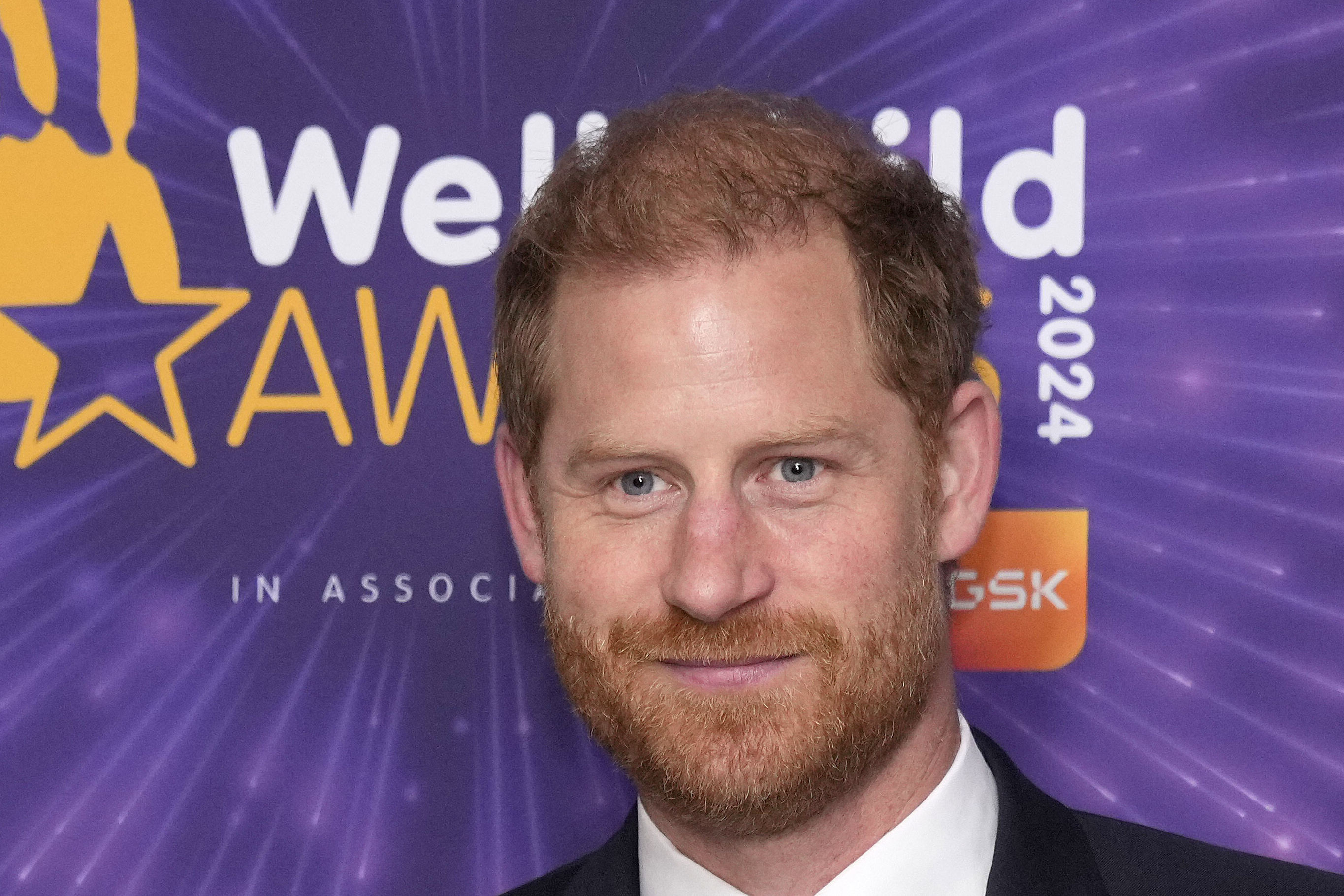 Prince Harry smiles on the red carpet at an awards show