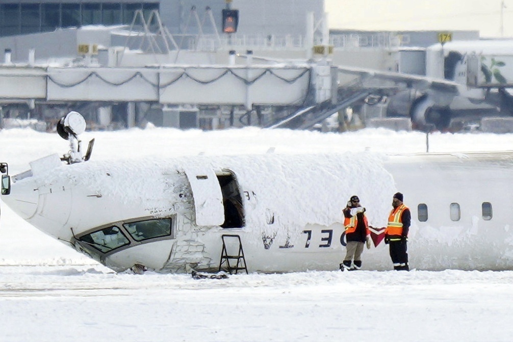 A Delta Air Lines plane lies upside down at Toronto Pearson Airport on Feb. 18, 2025.