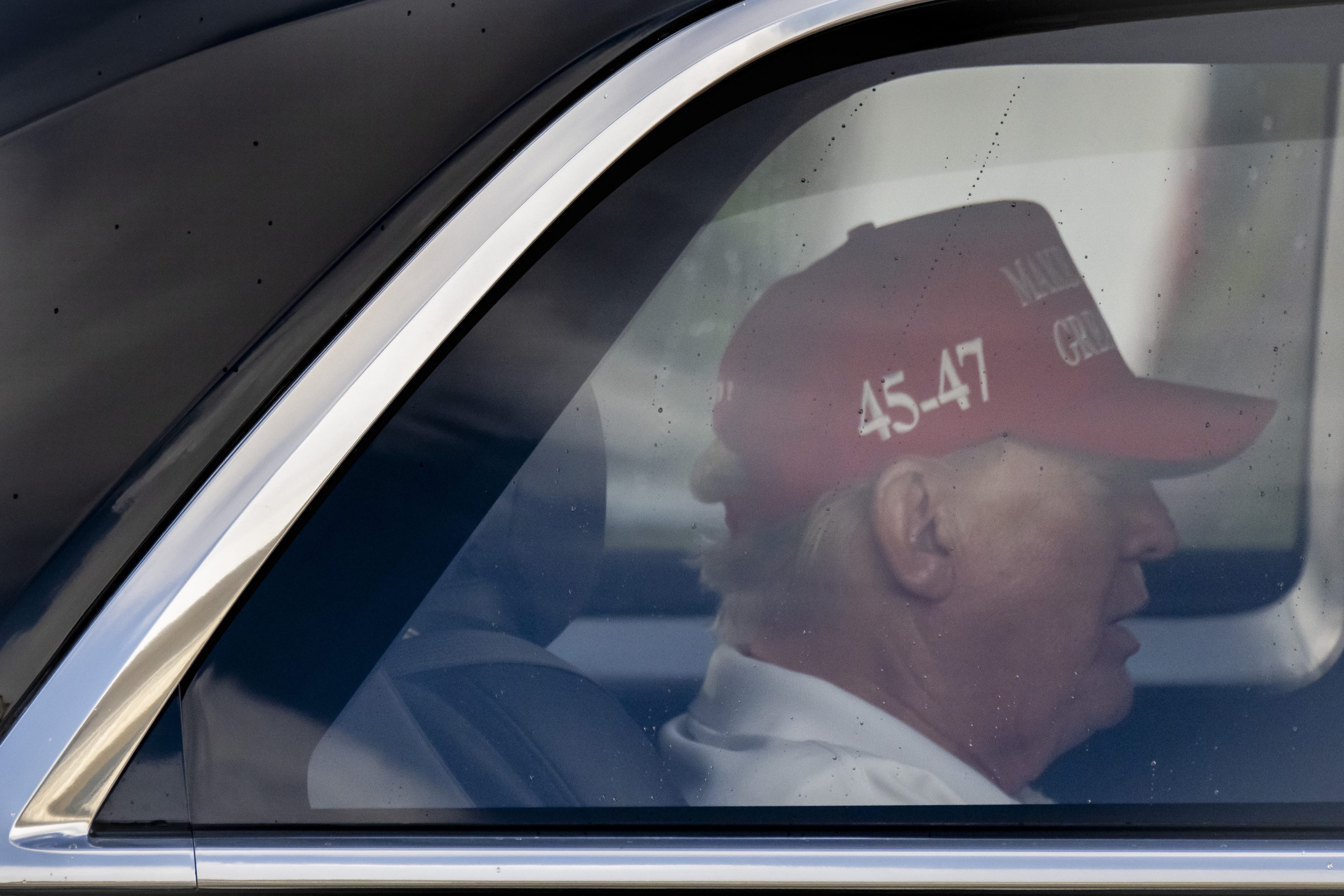 A side profile of Trump as he sits in his motorcade