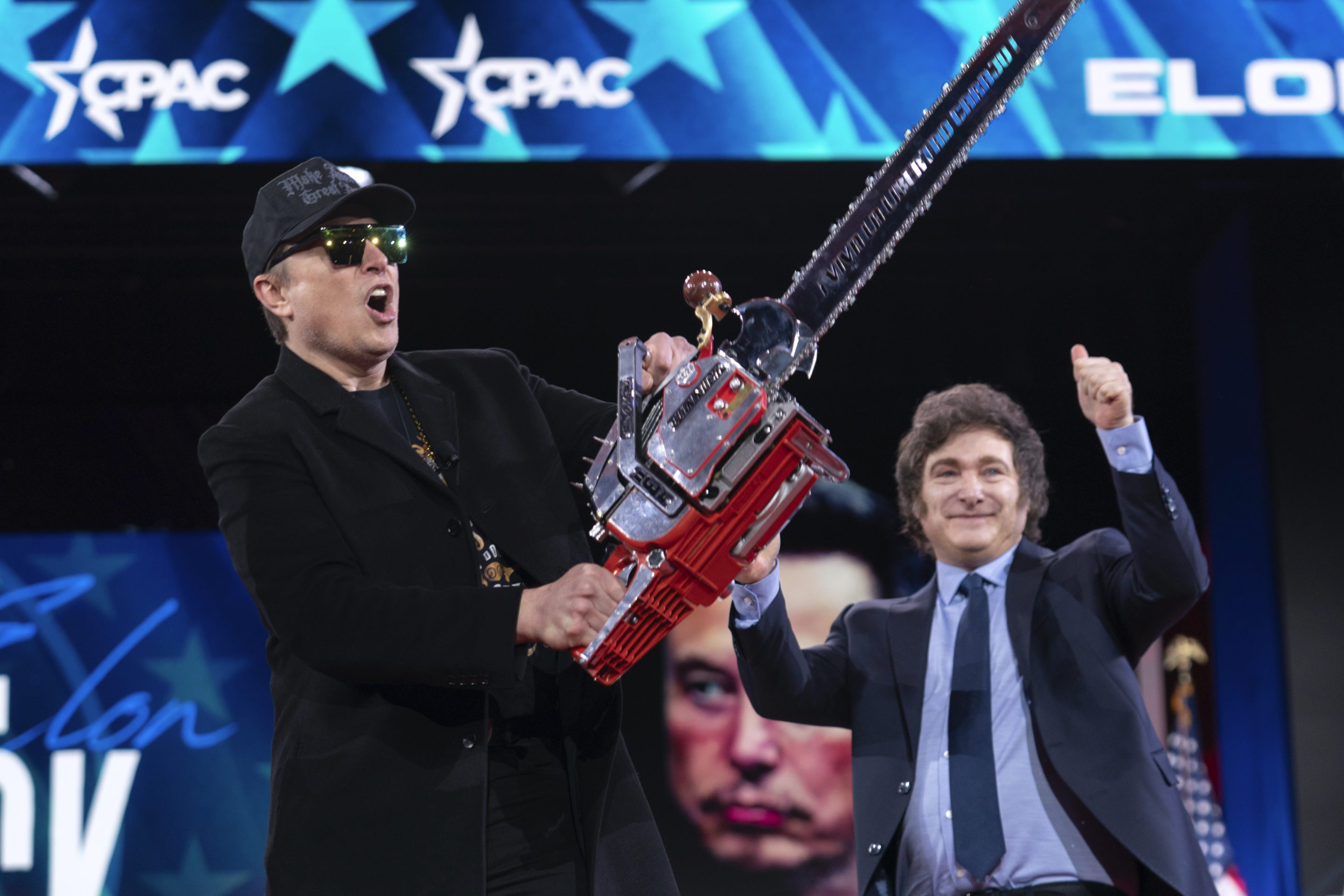 Elon Musk wields a chainsaw