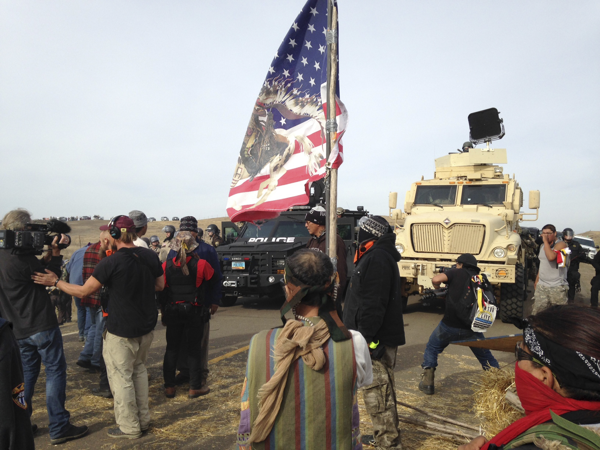 Dakota Access pipeline protesters defy law enforcement officers who are trying to force them from a camp on private land in the path of pipeline construction, Oct. 27, 2016, near Cannon Ball, N.D.