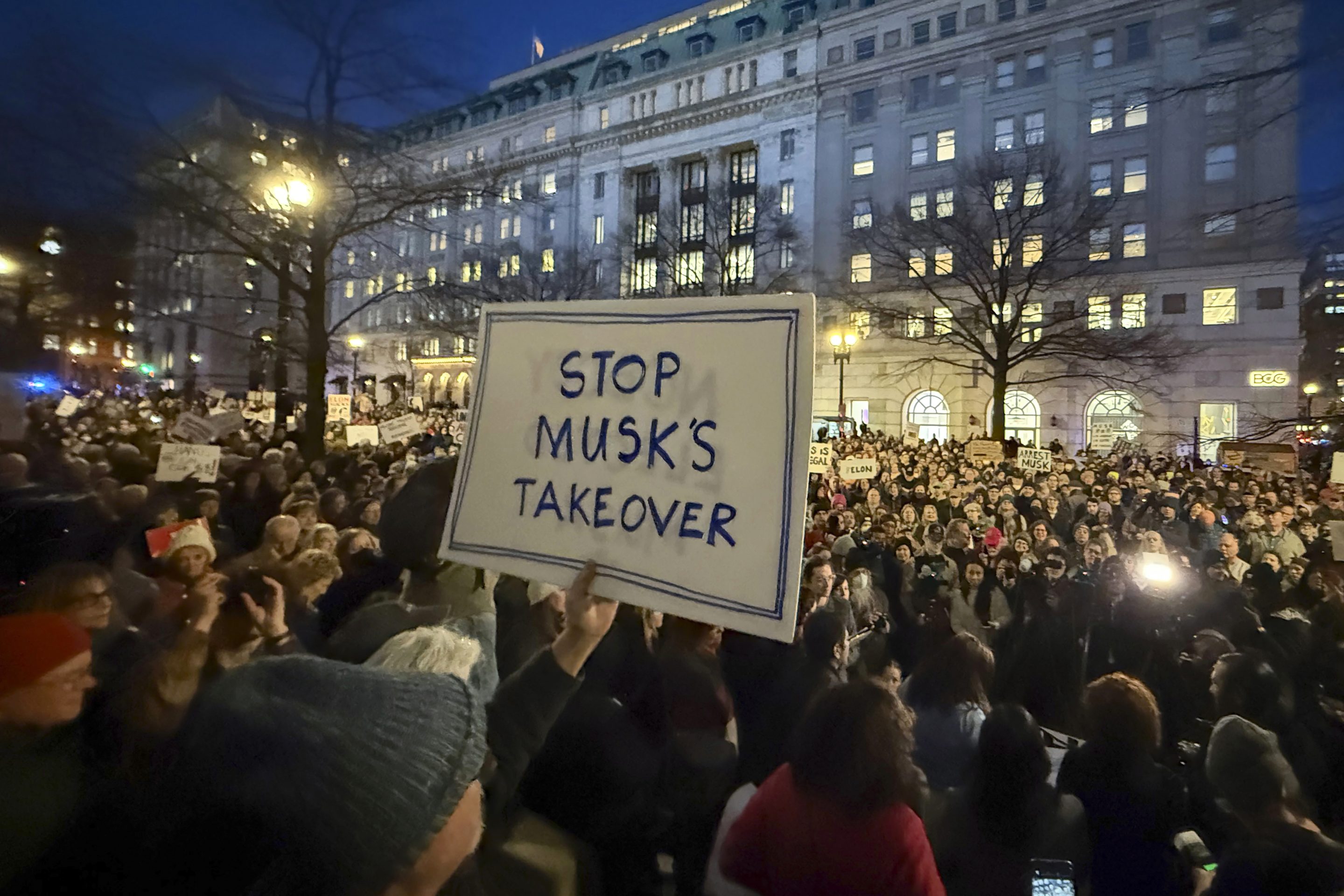 People protest during a rally outside the Treasury Department in Washington, Feb. 4, 2025. 