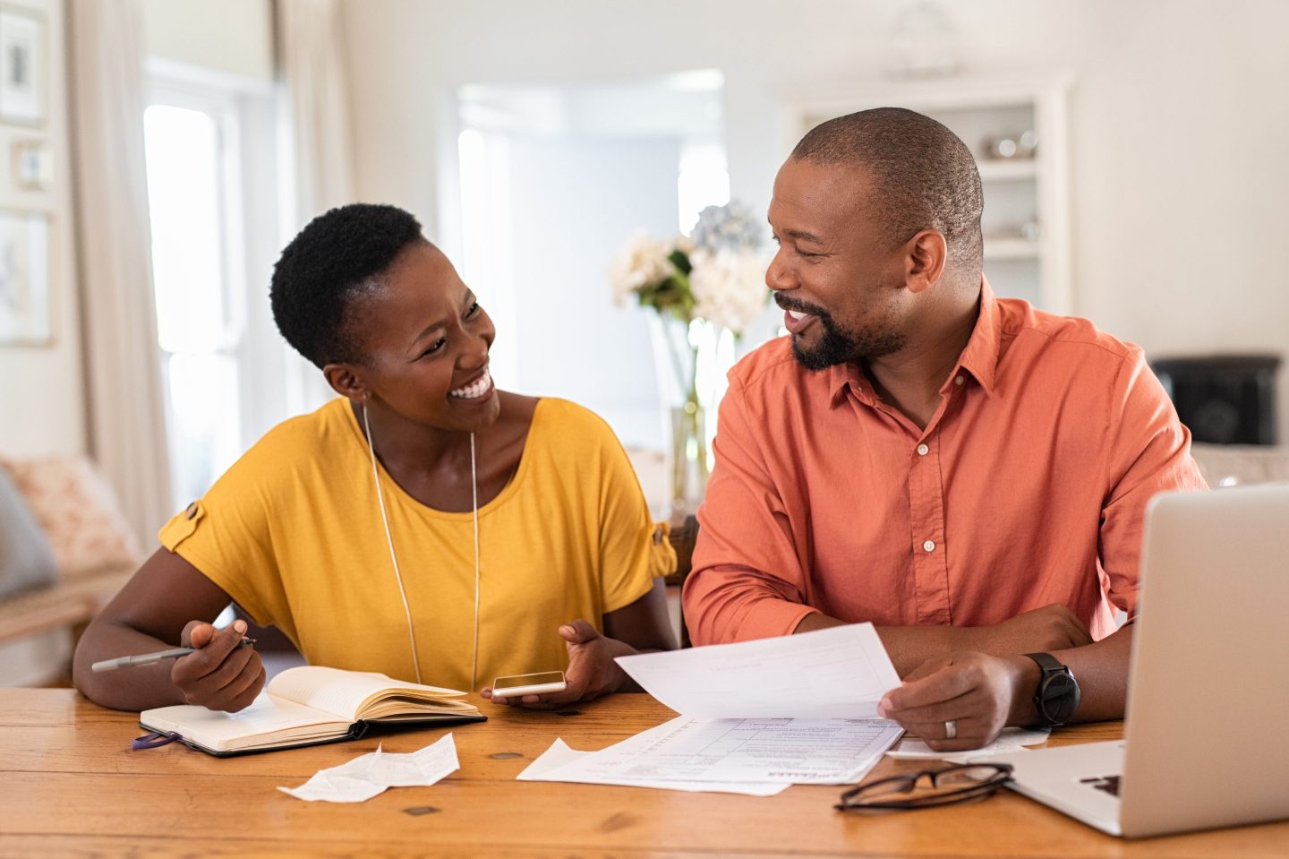 Two people going over forms happily.