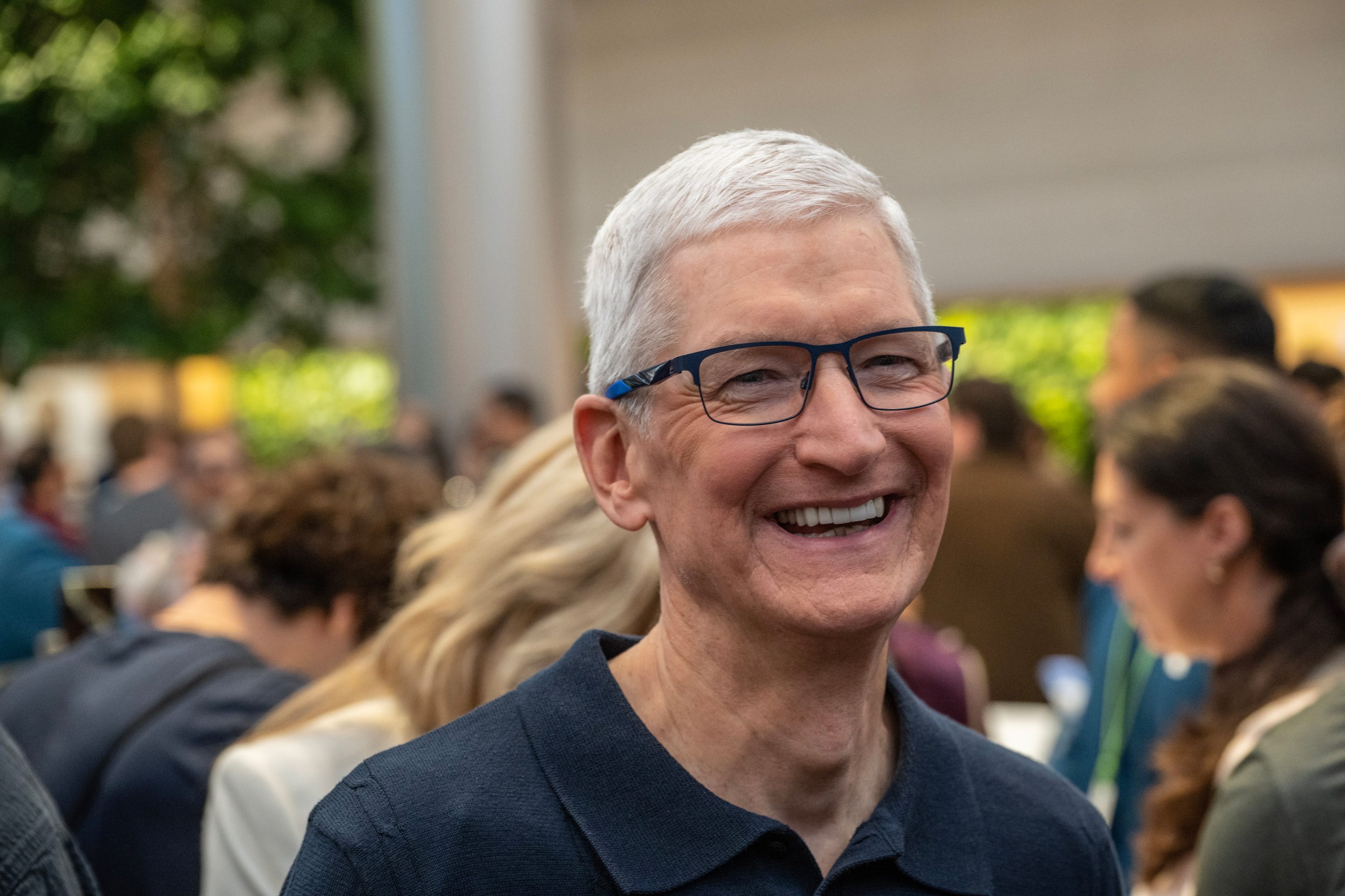 Close up of Tim Cook smiling outside.
