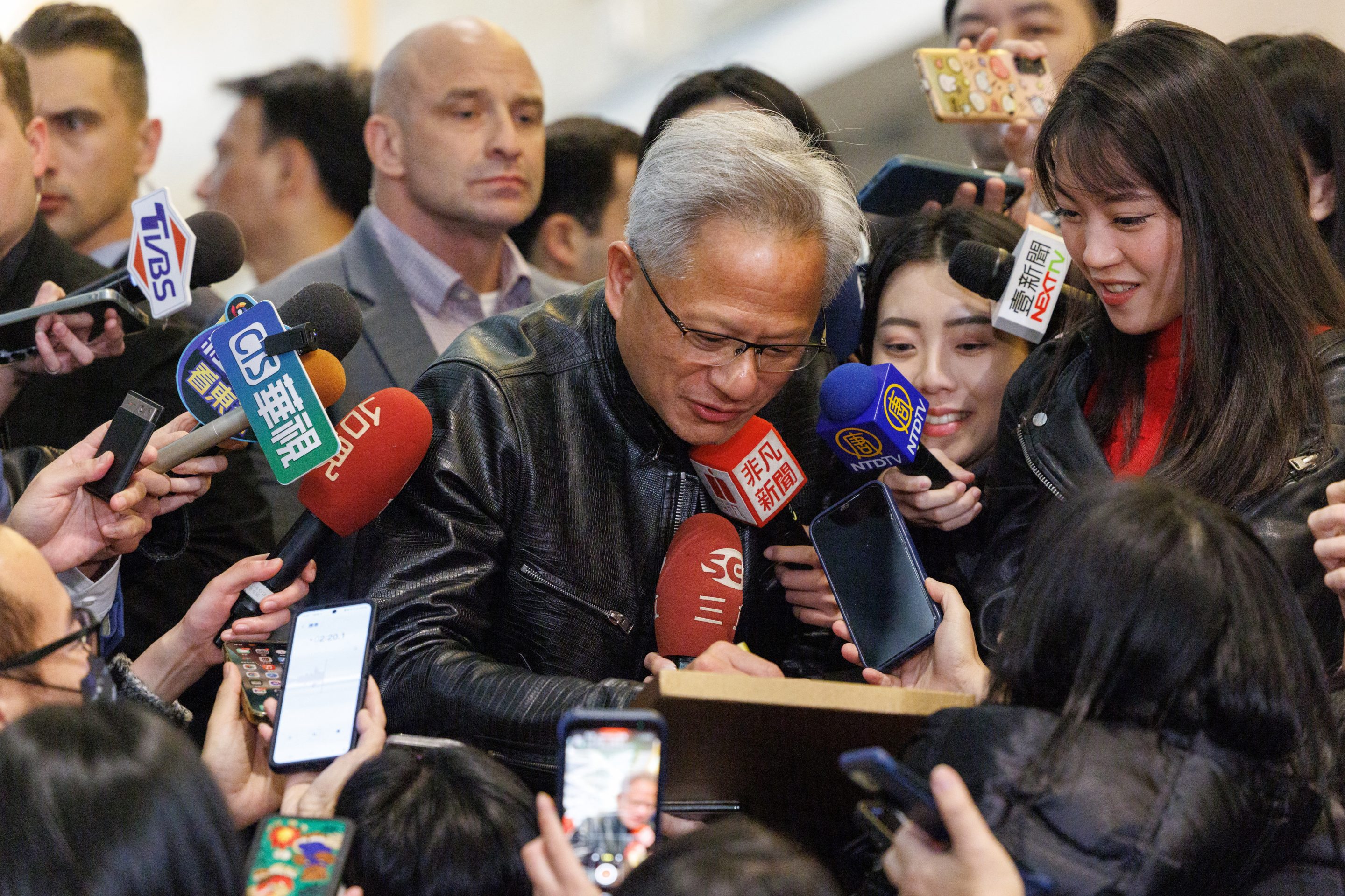 Nvidia CEO Jensen Huang is swarmed by reporters