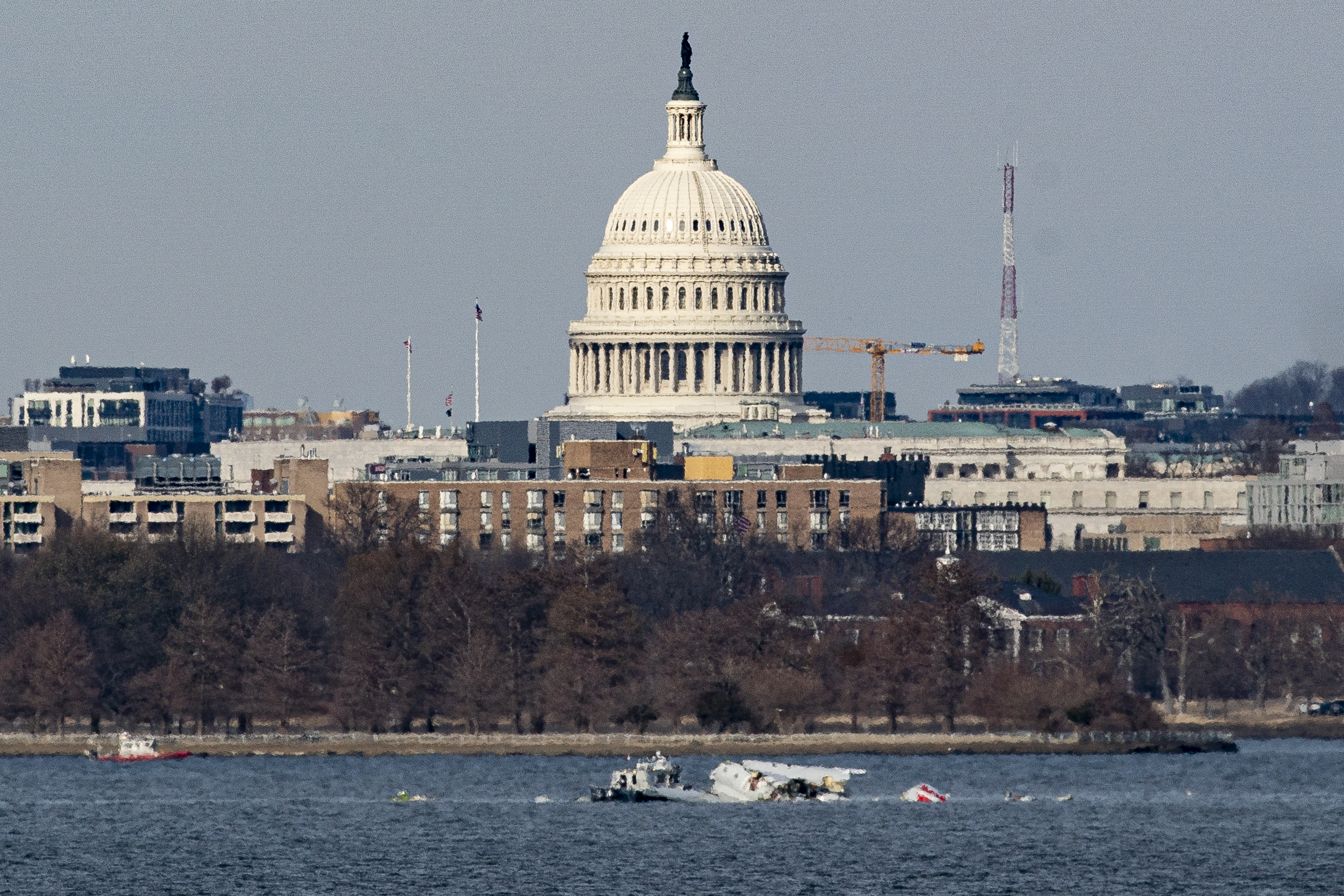 Emergency response units work at the crash site of the American Airlines plane on the Potomac River after the plane crashed last night on approach to Reagan National Airport on Thursday.