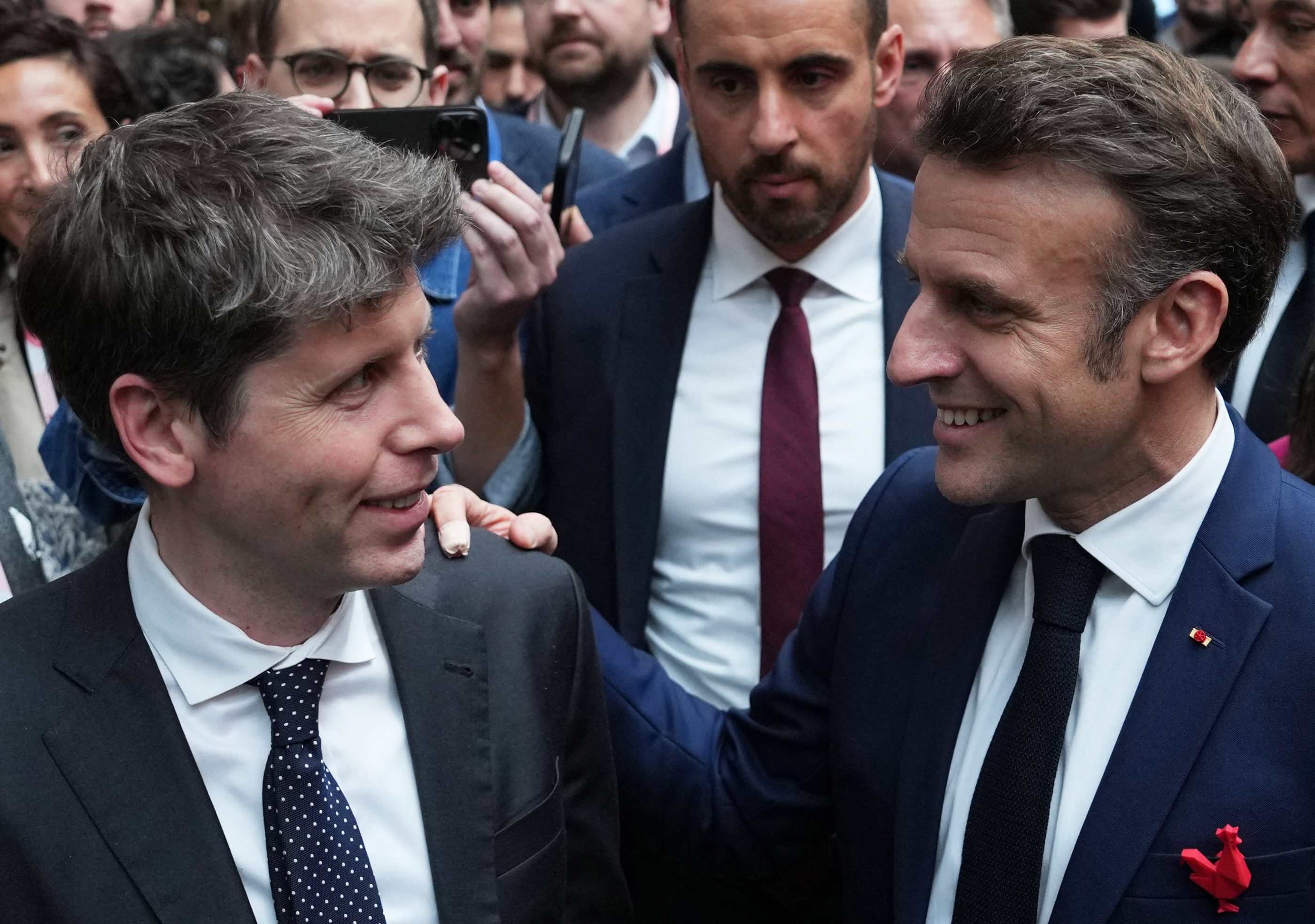 French President Emmanuel Macron speaks with Sam Altman, CEO of OpenAI.