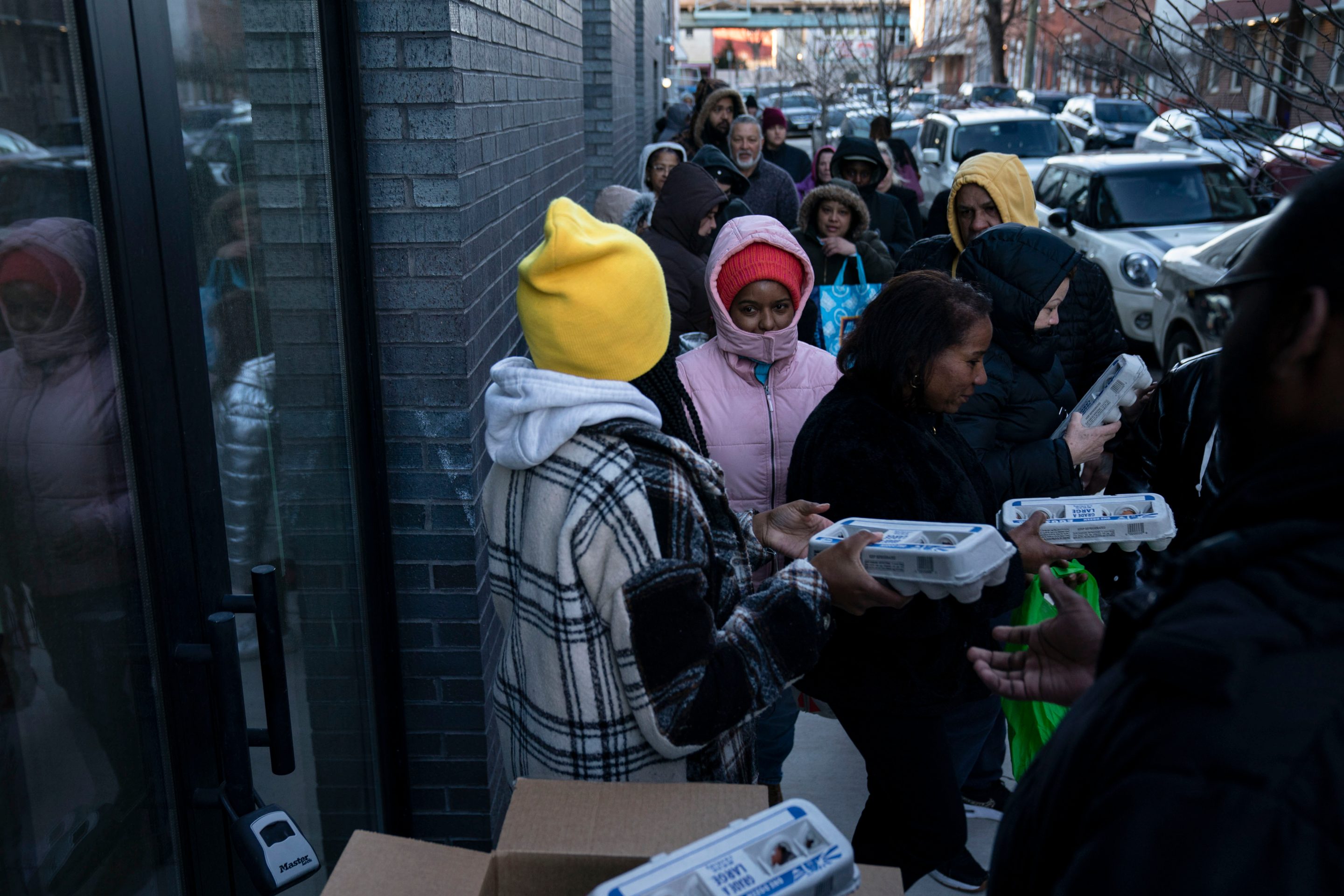 Residents wait in line to receive free cartons of eggs in the Kensington neighborhood of Philadelphia, on Friday, Feb. 25, 2025, as egg prices surge nationwide.