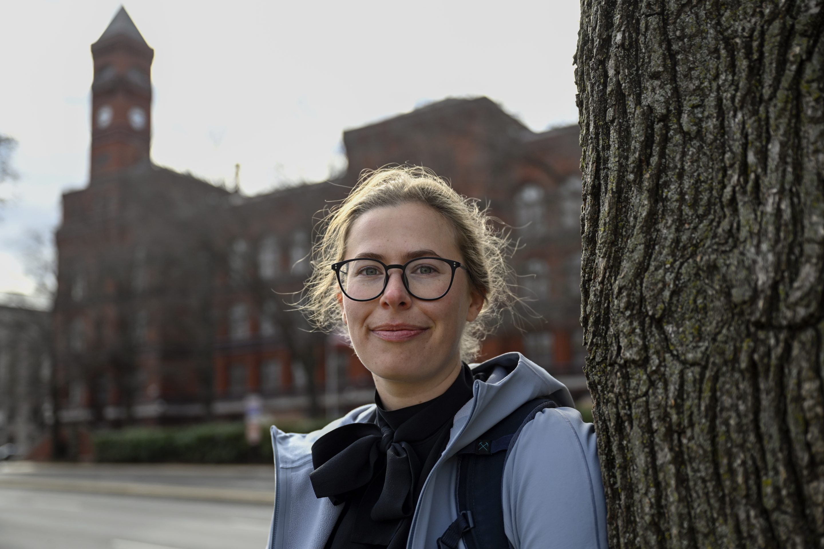 Sydney Smith, who lost her job due to DOGE cuts, stands in front of the Sydney Yates building that houses the Forest Service on March. 6, 2025, in Washington.
