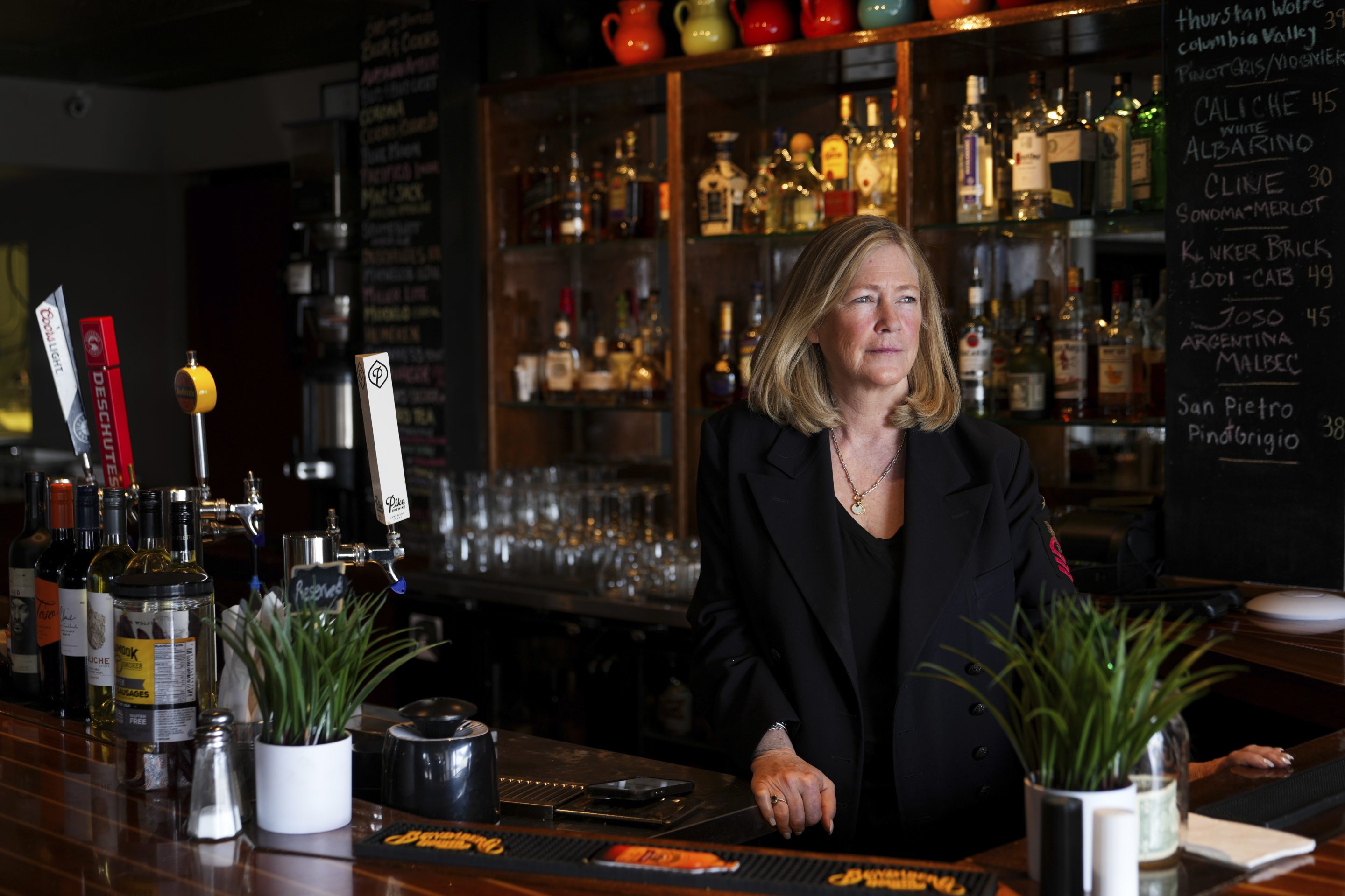 Tamra Hansen, a dual citizen of Canada and the United States, poses for a portrait at her restaurant, The Pier, which is down over fifty percent in sales compared to last year, on March 17, 2025, in Point Roberts, Wash.