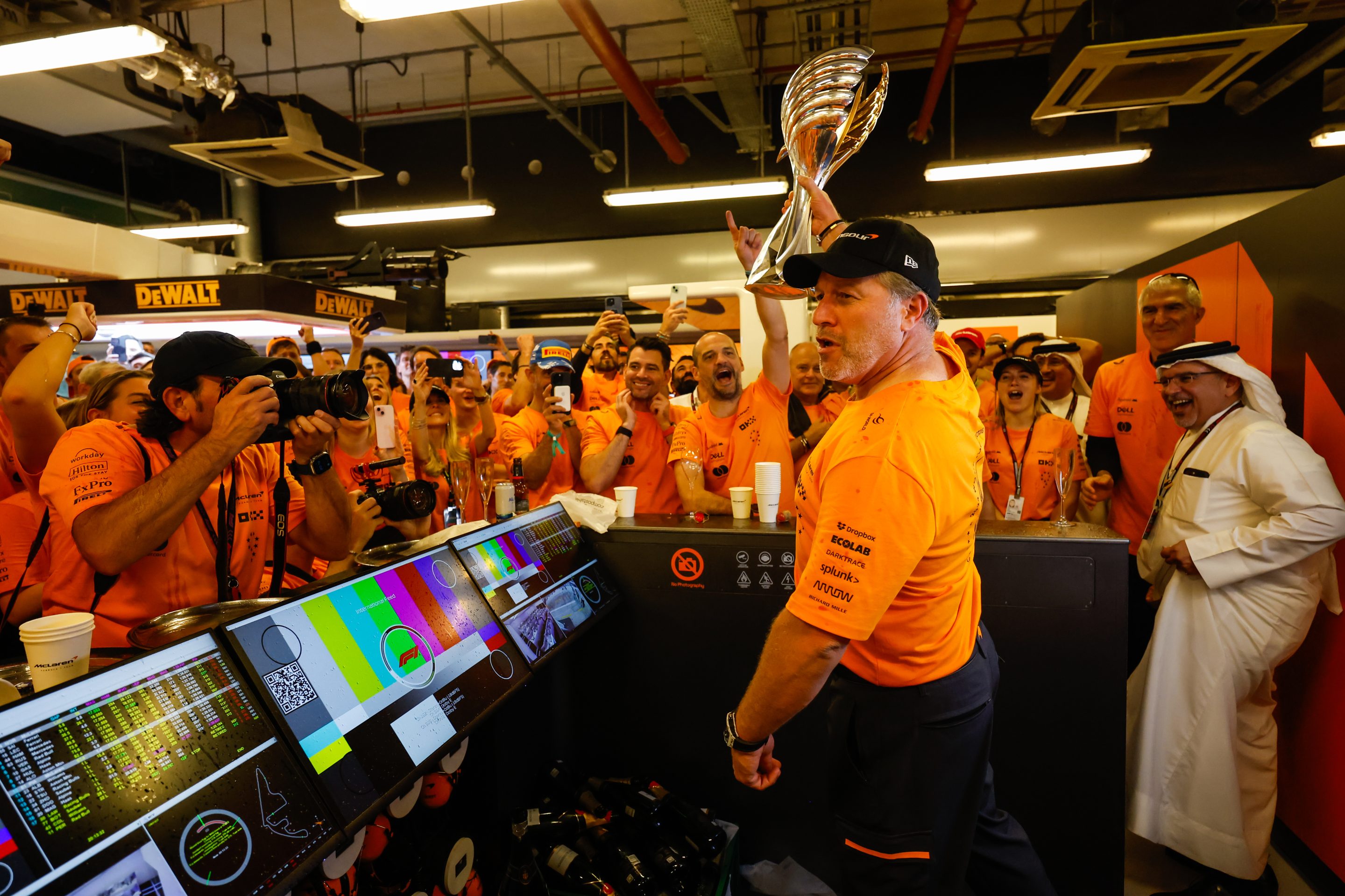 McLaren Racing CEO Zak Brown and team celebrate a win.