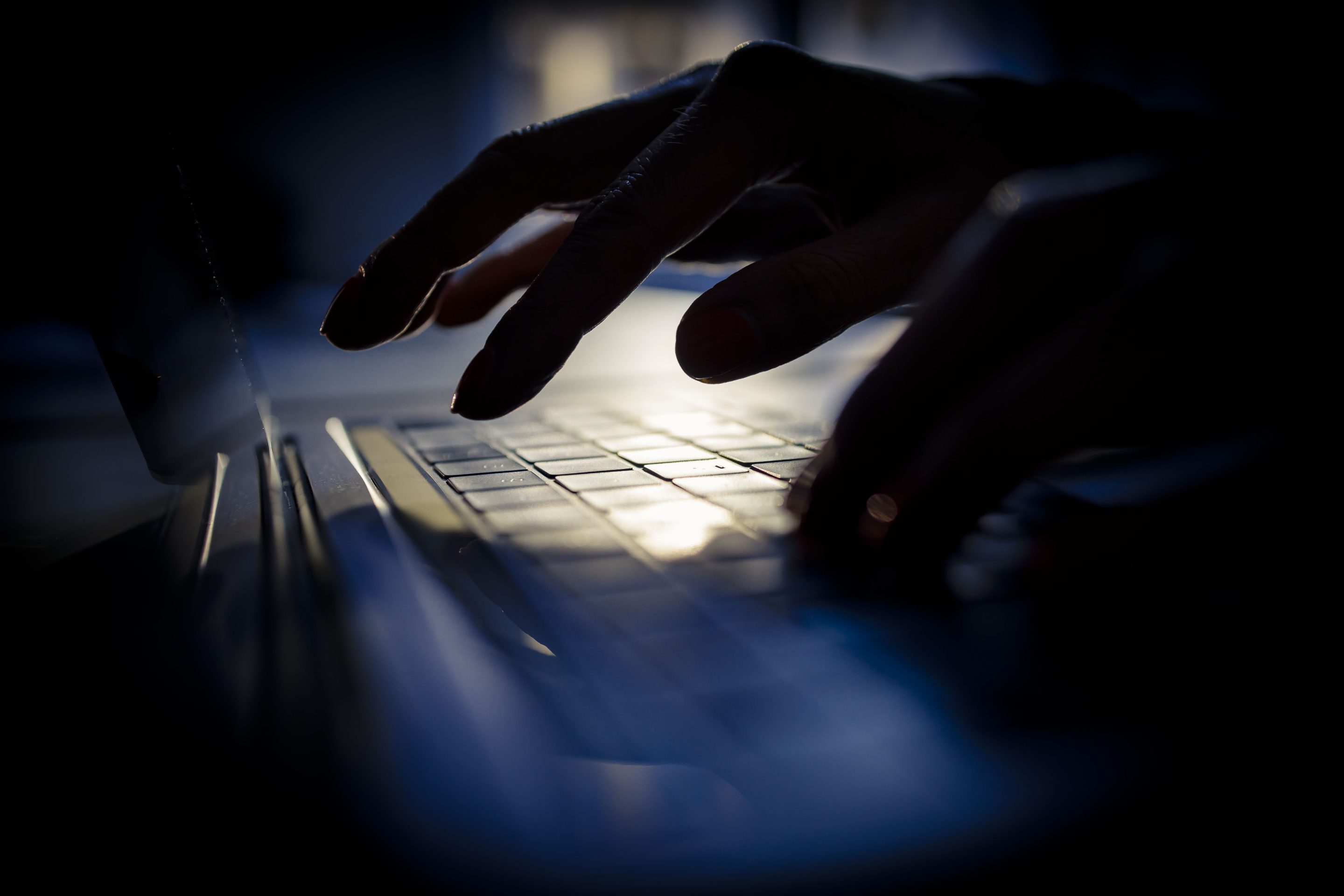 hand on computer keyboard