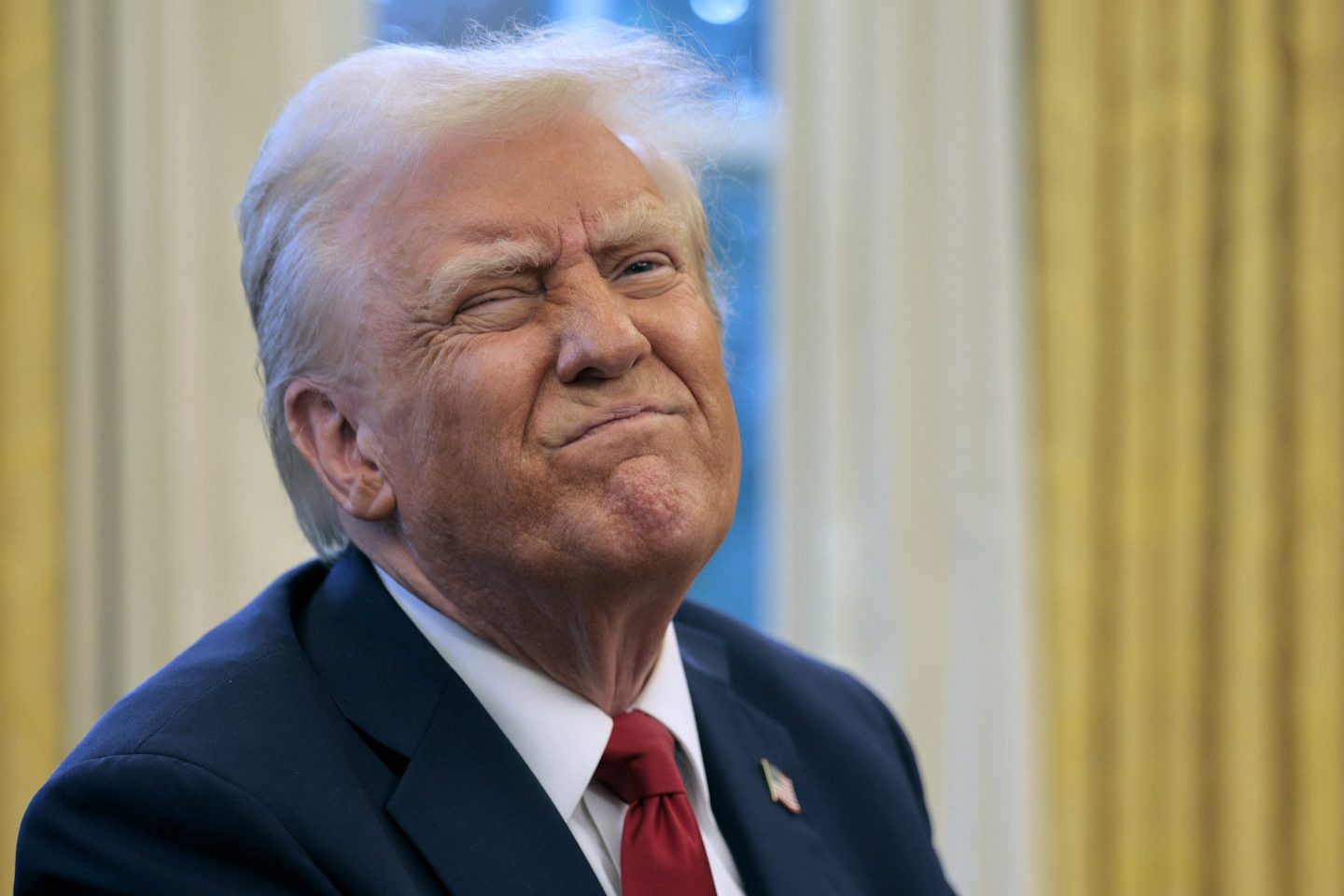 U.S. President Donald Trump reacts to a reporter's question
